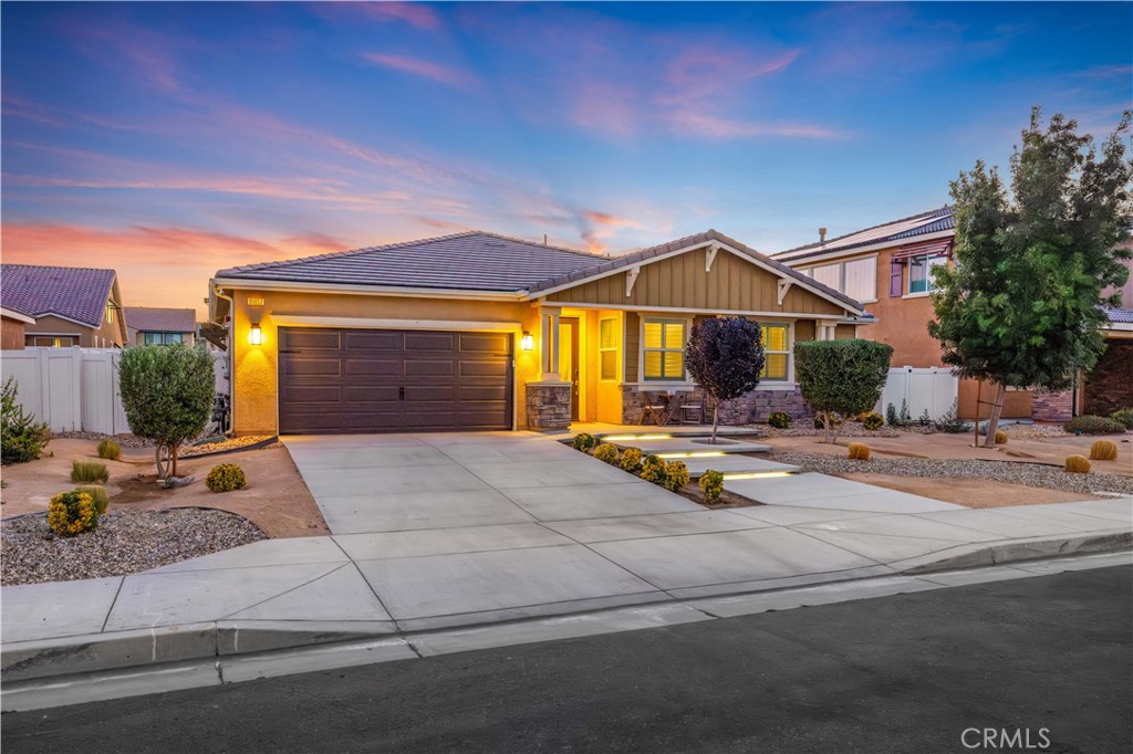 This stunning 4 bedroom, 4 bathroom home offers over 3,000 sqft of living space and sits on a spacious 7,851 sqft lot in a clean, newer community with no HOA! Built in 2021, this property combines desert modern design with top-of-the-line smart home features and energy efficient upgrades throughout. As you pull up, you’re welcomed with gorgeous curb appeal featuring a stone-accented exterior, beautiful drought-tolerant landscaping, an elegant custom front door, and custom-lit concrete stairs that lead you right to the entry. There’s also a cozy seating area in the front yard, perfect for enjoying your morning coffee while taking in the peaceful sunrise. Inside, you’re greeted with high ceilings, large windows that allow an abundance of natural lighting, and a bright, open floor plan that flows perfectly from the kitchen to the family room, perfect for entertaining guests! The kitchen features granite countertops, stainless steel appliances, a large island with bar seating, beautiful pendant lighting, a walk-in pantry, and shaker cabinets with plenty of storage. The spacious family room is complete with a sleek electric fireplace, built-in Sonos ceiling speakers, and smart blinds that work with the smart home system. Just off the kitchen, you’ll find a large formal dining area that’s currently being used differently, but offers plenty of room for a full dining setup and is equipped with smart blinds as well. All four bedrooms are generously sized and each offers either a private or nearby bathroom, plus walk-in closets! The primary suite is tucked away for extra privacy and includes a spa-like bathroom with dual sinks, a soaking tub, and a large walk-in closet. Tech lovers will appreciate the fully integrated Control4 + Josh.AI smart home system, CAT6 wiring, fiber internet, smart blinds, energy efficient double pane windows, tankless water heater, 220V for EV charging, and best of all; owned, paid-off solar! The backyard is ready for your dream setup, whether you envision a lot pool, outdoor kitchen, or relaxing garden. This home is walking distance to Marie Kerr Park, where you can enjoy summer concerts and watch the 4th of July fireworks show right from your yard! Close to Rancho Vista Golf Course, Antelope Valley Mall, shopping centers, restaurants, schools (Just a 2 minute drive to Summerwind Elementary, The IDEA Academy at Cottonwood, David G. Millen & Highland High school), and just minutes to the 14 Freeway for easy commuting.