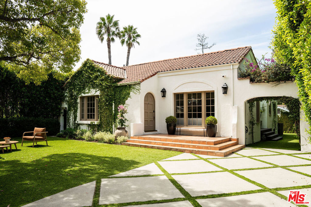 Looking for an oasis in the city? Welcome home to this stunning Spanish retreat nestled in one of Los Angeles' most beloved communities Brookside, just south of Hancock Park. Blending classic charm with modern sophistication, this chic escape offers a rare opportunity to live your own California Dream. Secluded beneath a lush tree lined canopy and set aback on desirable Tremaine Ave., this home will take your breath away the moment you step inside. Renovated to perfection with original details intact, gated for privacy and increased outdoor space, bathed in light at every turn, and thoughtfully updated, this home offers a rare balance of pedigree, warmth, elegance, and functionality. Sip your morning coffee, read your favorite book and start your day on your private front patio or curated front garden complete with classic Spanish tiles and beautiful bougainvillea. Step into a warm and inviting world of light-filled interiors, graceful architectural details, and an intuitive open concept flow designed for both everyday living and effortless entertaining. Classic features include arched doorways, pocket doors, oak hardwood floors, large kitchen island and separate pantry and walk-in laundry area are just some of the features that make this home unique. Natural light abounds from floor-to-ceiling windows in the charming living room that makes for the perfect place to hang, relax or get comfy. Perfectly placed dining room offers the ideal spot to host parties, and enjoy abundance with loved ones, while the chef's kitchen anchors the home with oversized soapstone island, counter-to-ceiling subway tile, professional grade appliances and large built-ins. Three large bedrooms each with their own ample closet space create functionality. Plus a lovely guest bathroom with an oversized tub and stand alone shower. You will be blown away by the primary space with double walk-in closets, custom built shelving and drawers plus dual marble vanities in the spectacular ensuite with oversized shower. French doors lead out to the backyard where a Zen-like world awaits; your own serene retreat in the heart of the city where you can dine under the stars, host parties, BBQ, and soak in those long LA summer nights. Detached space includes two distinct bonus spaces: a permitted ADU, with full its own bath, perfect as a guest house, and additional separate office space that provides the ideal work from home environment, home gym or creative space. With Solar Panels, a Tesla Power Wall plus an EV charger you can be both chic and green. Close proximity to some of the best the neighborhood has to offer; Memorial Park with its fabulous library and play place 4 blocks away, easy access to the Westside off Olympic or all that Larchmont and Hancock Park have to offer with bi weekly farmers markets, and chic restaurants and shops at door step. With its unparalleled location, enduring style, and sense of community, 911 South Tremaine is more than a home; it's a lifestyle.