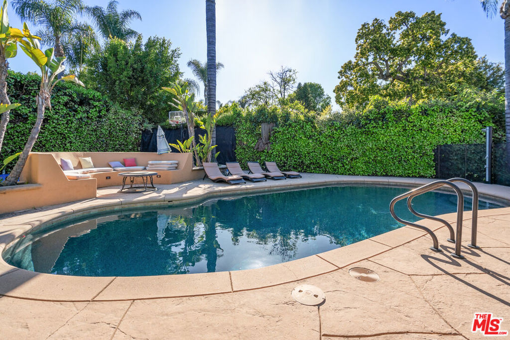 Discover California-Tuscan elegance in this stunning 3 bed 3 bath Sherman Oaks estate, set on a 10,000+ sq ft lot south of the Boulevard. Designed for entertaining, the private outdoor oasis features a saltwater pool, fire pit, BBQ island, and full basketball court surrounded by citrus trees. Interior, nearly 3,000+ sq ft (including bonus room) of luxury living includes a grand chef's kitchen with Viking appliances and Carrara marble, a serene primary suite with spa-like bath, a movie/game room, and a versatile flex space. With solar panels, 4-car parking, and prime access to local hotspots, this home is the ultimate blend of style, comfort, and convenience.