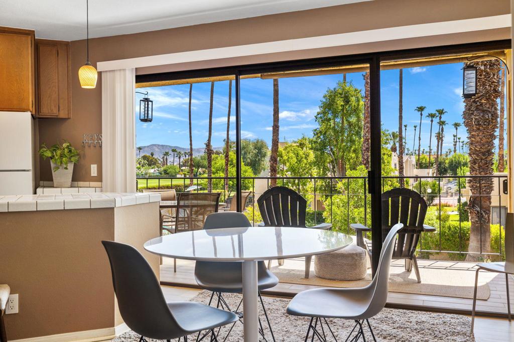 No land lease - you own the land! This furnished 1 bed, 1 bath second-floor condo offers authentic mid-century charm with panoramic views of the golf course, pool, mountains, and swaying palms from a spacious tiled balcony. Located in the coveted Palm Springs Golf & Tennis Club, this retro gem features original 70s details like a sunken tub and vintage cylinder shower, plus new wide plank vinyl flooring and a brand-new HVAC system installed in June 2025.The east-facing layout fills the space with morning light and afternoon shade. The original kitchen layout features lowered countertops and updated white tile surfaces, preserving its character while offering practical updates.HOA dues include water, trash, cable, internet, roof and exterior maintenance, plus access to resort-style amenities: 3 pools, 4 spas, tennis courts, pickleball, and clubhouse. Prime South Palm Springs location just minutes to downtown, shopping, dining, and hiking.