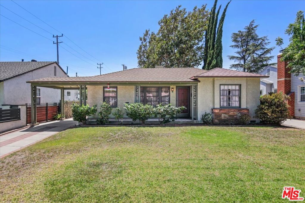 First time on the market in 75 Years! This Burbank classic single-story traditional ranch with timeless charm is nestled on one of Burbank's most picturesque tree-lined streets, just moments from the beloved Chandler bike path. This character-rich home radiates warmth, history, and endless potential. Flooded with natural light, the thoughtfully designed floor plan offers an effortless flow. The inviting living room features a stately fireplace flanked by built-in shelves ideal for books, art, or memories in the making. A formal dining room sits just off the living room, overlooking the lush front lawn and garden, creating the perfect setting for gatherings. At the heart of the home, the kitchen boasts a custom-built breakfast bar crafted by the family's late patriarch, offering a unique blend of craftsmanship and modern foresight. A dedicated laundry room provides access to the backyard. Two well-proportioned bedrooms and two classic original bathrooms are situated on the opposite side of the home, ensuring privacy and comfort. The generous family room connects seamlessly to both the kitchen and bedroom wing, and features a hidden built-in Murphy bed, allowing the space to double as a guest room when needed. Sliding glass doors open to the pool-sized yard anchored by a majestic, mature tree offering shade, beauty, and a sense of place. Perfect flow for ultimate SoCal indoor-outdoor living, entertaining, and future expansion. A detached two-car garage completes the offering, adding convenience and flexibility. Lovingly maintained and ready for its next chapter, 1115 N Niagara is more than just a home; it's a rare opportunity to become the next steward of a property filled with heart, heritage, and possibility.