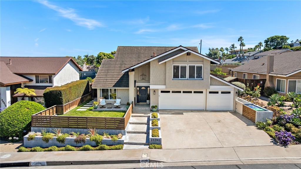 Welcome to coastal living at its finest! Just minutes from the ocean, this beautifully remodeled 4-bedroom, 3-bathroom home offers the perfect blend of style, comfort, and function on a spacious, flat lot. Soaring vaulted ceilings and abundant natural light set the tone the moment you step inside, while thoughtful upgrades throughout—from luxury vinyl flooring and PEX piping to solar panels and a whole-house fan—provide peace of mind and modern convenience. The heart of the home is a stunning kitchen featuring quartz countertops, a granite island with waterfall edges, stainless steel appliances, and full views of the backyard oasis. Designed for entertaining, the private yard includes a Komodo charcoal grill, built-in prep space, multiple seating areas, café lighting, fruit trees, and even an outdoor shower. Inside, custom touches like arched built-ins in the family room, a striking stair railing, and a smartly designed office nook add character and charm. The fully finished garage doubles as a fun and functional man cave, and all four bedrooms include ceiling fans and recessed lighting. Retreat to the spacious primary suite, where you’ll find a walk-in closet and a remodeled bath with a rainfall showerhead, dual vanities, and a stylish barn door for a coastal-chic touch. All three bathrooms have been tastefully customized with a light, beachy flair. To top it all off, this home enjoys an enviable location—just minutes to Dana Point Harbor, world-class beaches, scenic coastal trails, and the vibrant charm of downtown San Juan Capistrano.