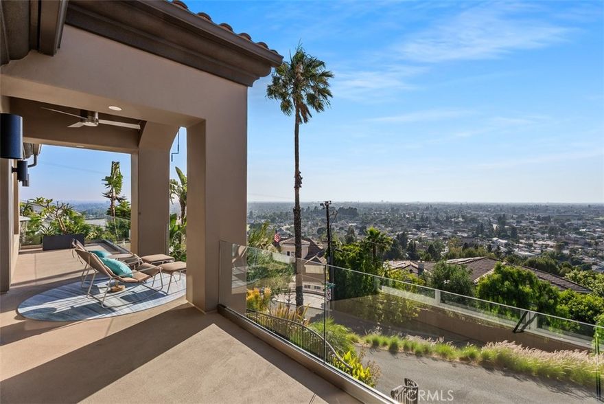 WOW. THIS IS A STEAL!!! Imagine waking up to unparalleled vistas that stretch from Catalina Island to the vibrant skyline of downtown LA to the majestic peaks of Mt Wilson. Welcome to your dream home – a sanctuary where elegance, comfort, and privacy unite in perfect harmony.  Let the magic of fireworks from Disneyland light up your nights, creating memories that last a lifetime.  This custom home was built to maximize the views from almost every room and outdoor space.  Sit down views from the expansive covered front porch, a view balcony from the main living level, and a huge roof deck complete with fireplace, island, and barbeque area.  The inground spa was designed to provide views through the windows out to the sparkling evening lights.



This home checks all your boxes, freshly painted, new garage door, Level 2 charger, driveway that can accommodate at least 6 cars, lush low maintenance landscaping, and privacy. Updated kitchen with a 6’ triangular island with raised counter seating. Built-in Thermador refrigerator, 6 burner stove, newer Bosch dishwasher, microwave drawer and beverage frig. The massive great room (40’x29’) is the hub of the home where living, dining, and meal prep all open to one another. French doors take you to the rear yard that is thoughtfully tiered.  A bridge connects the rear yard to the roof deck, which enables easy access to this special entertaining space.



The specialty stone and tile work make this a very unique property, from the Bahia Blue granite thresholds upon entry to the slab Travertine stairs.  The primary bathroom was recently renovated with porcelain tile walls, Carrera marble pebble tile floors that take you into a curbless shower with dual shower heads and a Mr. Steam shower system.  A relaxing island tub, electric towel warmers, tankless bidet toilet enhance the spa-like feeling.  A new large capacity Navien tankless water heater with recirculating pump and filter makes maintenance hassle-free.
