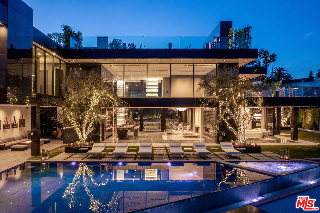Welcome to La Fin, or The End, an apt title for the ultimate, final example of modern decadence and refinement; the be-all and end-all experience in one of the world's most famous and exclusive enclaves. Sited on a two-acre parcel, this magnificent residence offers 12 spacious bedrooms, 17 bathrooms, remarkable amenities, and brilliant panoramic views of Los Angeles. Just beyond the gated motor court, proceed down to the oversized glass entryway to one of the most beautiful and opulent homes the globe over. A spiral staircase surrounds a stunning 44-foot chandelier made of 55,000 crystals, a showstopping centerpiece yet just one of the impressive custom lighting sculptures throughout the home. The main level features a custom stone bar that flows into the formal living area with a massive hand-carved stone latticework fireplace. All furniture was custom-made for La Fin by Italian luxury brand La Contessina. Motorized Fleetwood pocket doors open to the infinity-edge pool with a striking 23-foot LED screen that rises at the touch of a button and a 30-person lounge area with fire pit. The lower level provides a 6,000-square-foot entertainment area with lofty 18-foot ceilings, custom bar, commercial-grade catering facilities, 1,000-bottle wine cellar, cigar lounge, ice-cold vodka tasting room, and a jaw-dropping automated six-car vehicle elevator display. Additional amenities on the lower level include an outdoor lounge area, luxury fitness center with rock climbing wall, spa, steam room with backlit onyx, massage room, and sound-proof cinema. The second level features a grand primary suite with Italian hand-crafted floor-to-ceiling oak cladding, lounge area, coffee bar, spa-like bathroom with Calacatta Gold marble, massive 100-square-foot shower, solid marble vanity, dual showroom-style walk-in closets, and private wraparound balcony with sweeping views, spa, fire pit, and TV. The rooftop deck offers additional outdoor/entertainment space with built-in seating, fire table, video screen, elevated spa, and even more incredible vistas. Staff residences and a detached guest suite offer ample space. Fingerprint technology and security command center provide the utmost privacy and safety. The meticulously designed and curated La Fin is a once-in-a-lifetime Bel Air estate that can only be admired but never replicated.