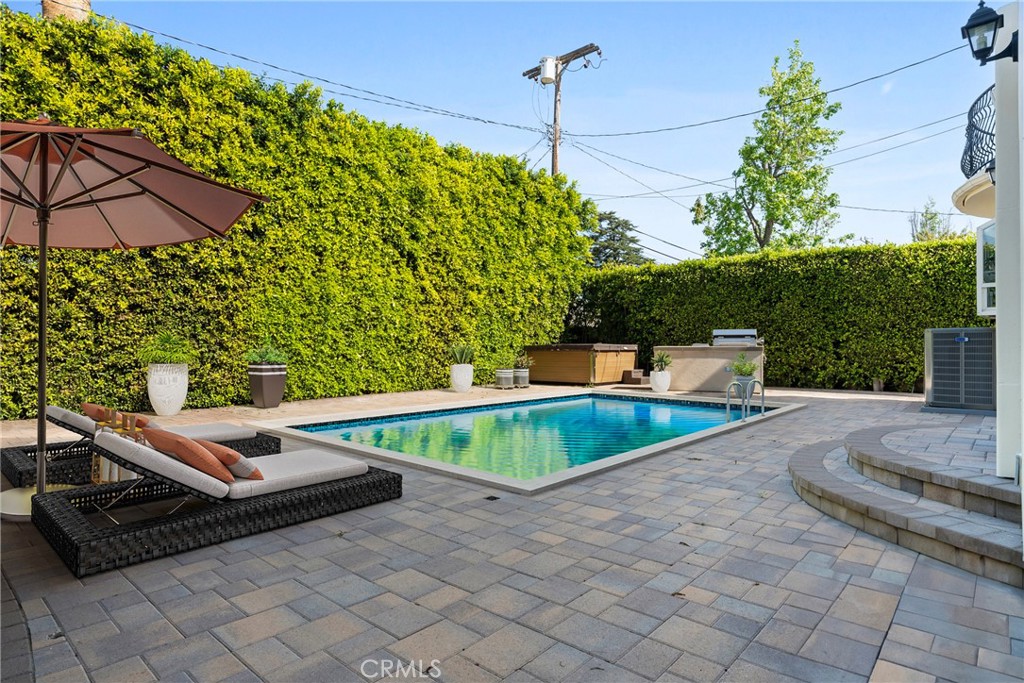 Luxurious, Fully Renovated Estate in Prime Sherman Oaks Welcome to a true masterpiece that has been completely reimagined from top to bottom for the most discerning buyer. Nestled in one of Sherman Oaks’ most prestigious neighborhoods, this stunning home blends timeless elegance with modern luxury, offering an unmatched living experience. From the moment you arrive, the newly landscaped front yard and grand curb appeal set the tone for what’s inside. Step into a world of refined sophistication, where brand-new tile flooring, recessed lighting throughout, and an expansive open-concept layout create a bright, inviting atmosphere. The oversized chef’s kitchen is a showstopper, featuring a huge center island, top-of-the-line finishes, stainless steel appliances and plenty of space for preparing meals and hosting guests—an entertainer’s dream come true. Downstairs, you’ll find a dedicated laundry room, stylishly designed for function and convenience. Upstairs, one of the bedrooms opens onto a private balcony, offering a perfect spot for morning coffee or sunset views. The primary suite is a luxurious retreat, boasting a massive walk-in closet and a spa-like bathroom complete with dual vanities, a soaking tub, and a separate walk-in shower—crafted to offer both beauty and serenity. Step outside into your private backyard oasis, surrounded by tall, lush hedges offering total seclusion. Entertain effortlessly with a private built-in BBQ, expansive patio space, and endless room for outdoor dining, lounging, or even adding a pool. The property also includes a gated two-car garage and a large driveway, providing ample parking for guests or additional vehicles. Located just minutes from Ventura Boulevard’s best shopping, dining, and entertainment, this home delivers the ultimate luxury lifestyle in a premier Sherman Oaks location. This is more than a home—it’s a statement. Schedule your private tour today and experience true luxury living!