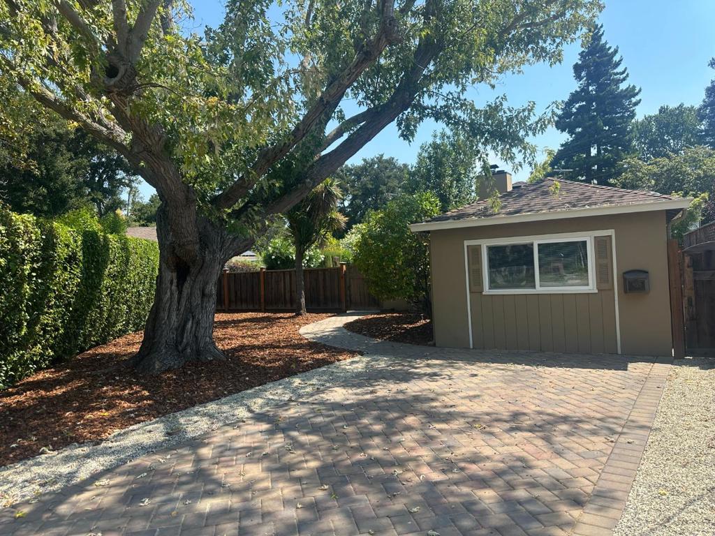 Welcome to 952 Timothy Lane in Menlo Parks sought-after Bay Road Oaks/Suburban Park neighborhood! Nestled on a quiet U-shaped street, this charming single-family home sits on a unique pie-shaped lot, offering privacy and a serene retreat-like setting. Inside, enjoy refinished hardwood floors, a new kitchen with white cabinetry and stainless-steel appliances, and a fully remodeled bath with stylish finishes. The layout includes two spacious bedrooms, a dining room that opens to the light-filled living room with a wood-burning fireplace and a bay of large corner windows that fill the room with natural light. Step outside to your lush lawn, patio, and sparkling pool - perfect for relaxing or entertaining. Located within the highly regarded Menlo Park School District, and only a few minutes from Flood Park, which offers a playground and picnic areas. The Manor Shopping Plaza is just minutes away where you can enjoy a class at CorePower Yoga, shop for fine wine and groceries at Delucchis, savor pastries at Lavender N Cream Patisserie, or enjoy Mexican favorites at Los Gallos Taqueria. With easy access to the Highway 101 corridor and tech giants like Google, Facebook, and Oracle. This is more than just a rentalits a place to truly call home!