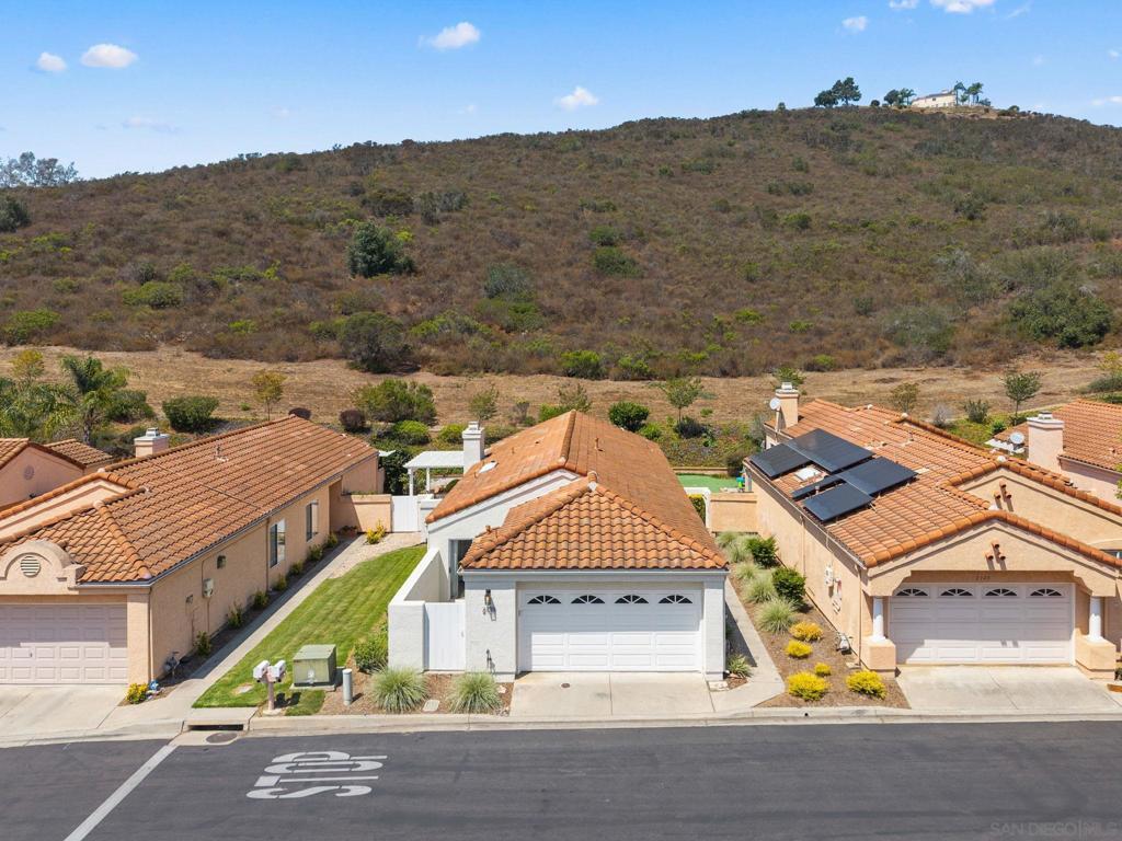 Welcome to 2139 Royal Lytham Glen! A serene single-story retreat tucked against a peaceful hillside in one of Escondido’s most desirable communities. This beautifully maintained home offers 3 spacious bedrooms and 2 bathrooms, thoughtfully designed for comfort and effortless living. The open-concept layout connects the living room, dining area, and kitchen, ideal for entertaining or cozy nights at home. The primary suite is a private sanctuary with an en-suite bath and exclusive access to a tranquil backyard patio - perfect for quiet mornings or winding down at night. Two additional bedrooms provide generous space for family, guests or a home office. Step outside to your beautifully landscaped backyard and enjoy the calming hillside views. Located in the sought-after Woodridge neighborhood, this community features quiet streets, cul-de-sacs, and well-maintained single-story homes. Enjoy a family-friendly atmosphere with private yards, nearby parks, shopping, a community pool with BBQs, and top-rated schools. The HOA ensures neighborhood standards are upheld, making it a desirable and welcoming community.