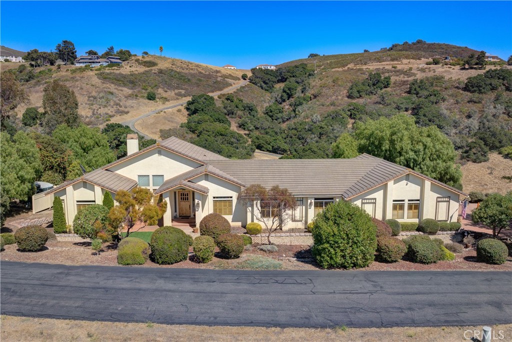 We are excited to share details about a remarkable property in the exclusive Highland Hills gated enclave in the Nipomo foothills. This custom-built, single-level craftsman-inspired home, built in 2003, offers the best of Central Coast living: unmatched privacy, expansive space, and incredible potential.
Tucked away on 10 serene and low-maintenance acres, this home spans approximately 2,832 square feet and includes 3 bedrooms and 2.5 baths. From its peaceful setting, you’ll enjoy breathtaking, panoramic views—from twinkling town lights to the distant ocean.
The open floor plan features spacious living areas, a welcoming fireplace, and a generous kitchen with custom Alder cabinets, a professional convection stovetop, and dual ovens—perfect for entertaining. The home is equipped with a complete HEPA-filtered forced-air heating system and an ultra-efficient backup solar battery system.
Additional highlights include a 3-car garage, an executive office for privacy and productivity, and a custom-designed, hand-built "covered bridge" carport with a weather-tight storage area or "she shed." Recent upgrades include new hickory floors installed just two years ago, and there's even potential for a wine cellar. The expansive outdoor deck is ideal for enjoying the mild climate and embracing the tranquil, private surroundings.
This property presents a rare opportunity—whether you envision a personal retreat, wish to expand with additional structures, or simply value space, peace, and a spectacular setting. Located within the Lucia Mar Unified School District and just a short drive from local shops, beautiful beaches, and renowned vineyards, it’s the perfect blend of rural charm and everyday convenience.