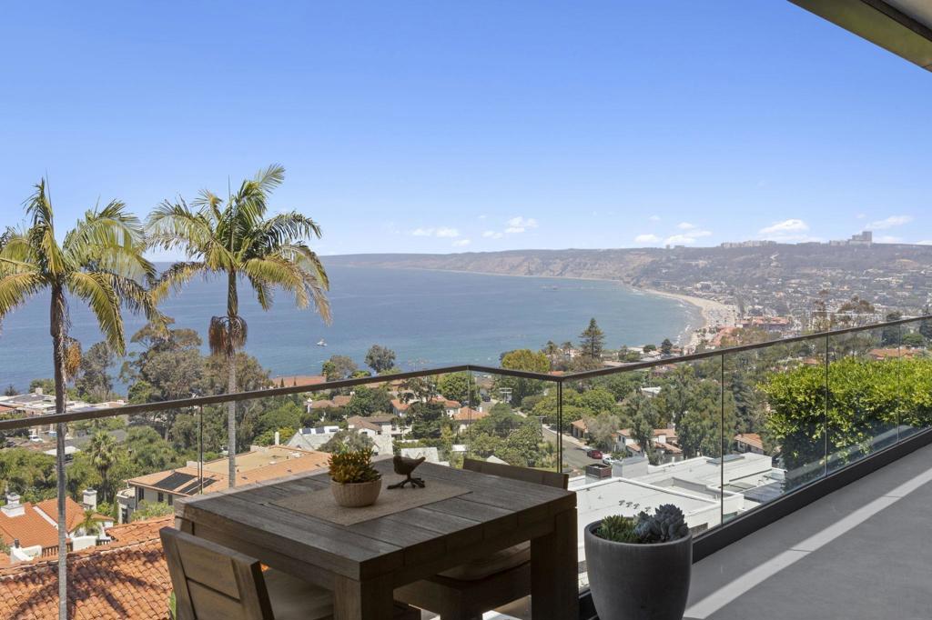 Set high in the prestigious Country Club neighborhood, this gorgeous estate captures sweeping ocean vistas and unforgettable sunsets. Surrounded by the natural beauty of the hills, the home offers a rare blend of privacy, elegance, and breathtaking scenery. Ideally located just minutes from world-class dining and shopping, the property also provides walkable access to the Village, Scripps Pier, and the scenic La Jolla Natural Park trails leading up to Mt. Soledad. Thoughtfully designed over three levels with entry on the main living floor, the residence lives more like a two-story, combining ease of everyday living with the sophistication of a coastal retreat.