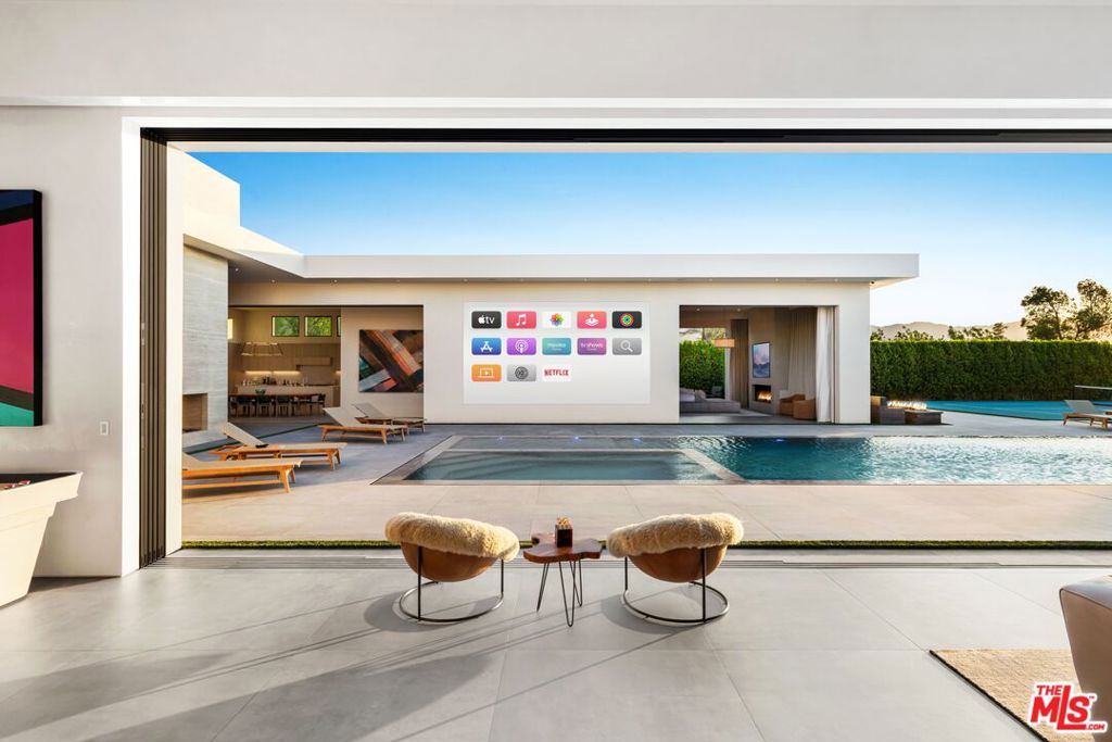 One of a kind stylish, cool and original family or friends mega-compound in the Madison Club with Approx. 10,000 SF under A/C and Approx. 13,500 SF under roof. Two luxurious master suites with his/hers baths and closets and 6 additional suites, two full Wolf kitchens - one is for guests, chef or large scaling entertaining. Total of 8 bedrooms and 11 beds. The compound features a pickleball court, an 80' zero edge pool, an oversized outdoor poolside movie screen, a covered patio with a see-through fireplace and an oversized motor court, carport and garages for a total of 20 car spaces inside the property with 10 of them covered/garaged. Top interior design with Italian cabinetry throughout and the finest materials.