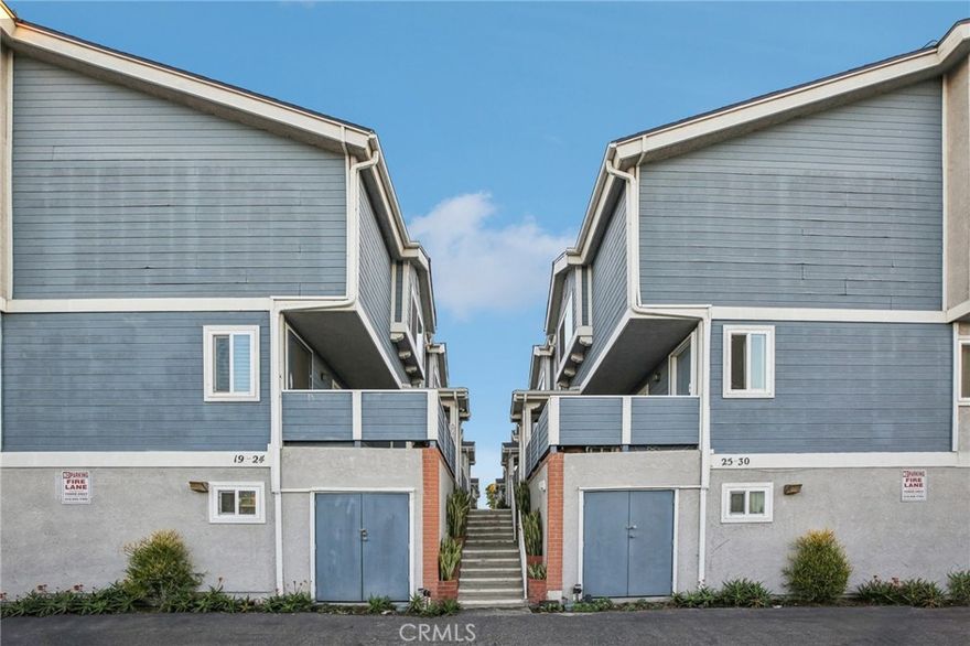 Dreaming of a breezy, coastal-inspired lifestyle in the heart of Carson? With its clapboard siding and classic architecture, this coveted multi-level townhouse offers the feel of a seaside escape without even leaving the city! Located in the gated Cape Cod Villas community, this 3-bedroom, 2.5-bath residence spans an inviting and move-in-ready 1,482 sq ft.

Past a wrought-iron gate and private entry, discover a bright interior where wood-style floors, recessed lighting, and timeless millwork create an atmosphere of comfort and refinement. Curl up by the fireplace in the generous living room or open the sliding doors to its secluded patio, ideal for relaxing evenings or casual al fresco meals. A wet bar enhances the adjacent dining alcove, making hosting gatherings seamless. The kitchen shines with its sleek granite countertops, a complement of stainless steel appliances, and plenty of cabinetry to keep everything within easy reach. 

Upstairs, each stylish bedroom displays vaulted ceilings, large closets, and soothing hues, while wide windows infused each retreat with natural light. The primary suite beckons you to unwind within the tub/shower combo of its tranquil ensuite. Downstairs, a flexible bonus room awaits your imagination as an office, gym, or guest room. An attached 2-car garage with laundry hookups adds everyday convenience.

Enjoy the perks of complex amenities, including a clubhouse, pool, and spa. With proximity to Harbor-UCLA Medical Center, major shopping hubs, local schools, and just minutes from the I-110, Long Beach, and LAX, this home blends accessibility and serenity with ease. Come see how effortless life can feel and imagine your next chapter beginning here!