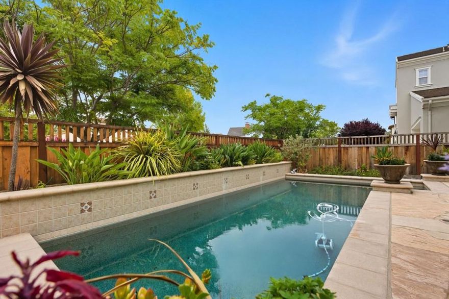 Spanning 4,401 sq ft, this exceptional residence features an expansive layout with elegant hardwood floors and refined finishes throughout. All five spacious bedrooms offer en-suite baths, complemented by a versatile office/tech room. The gourmet kitchen boasts quartz countertops, subway tile backsplash, a large island with bar seating, built-in fridge, gas cooktop, pantry, and casual dining ideal for daily living and entertaining. The inviting living area centers around a cozy fireplace. Enjoy California living with a modern pool, cascading waterfalls, poolside lounging, a courtyard with custom fountain and flowerpots, flagstone hardscape, and a semi-indoor lounge with fireplace. Additional highlights include a laundry room, 3-car garage, and a luxurious primary suite with retreat/exercise room, spa-inspired bath, and custom closets& cabinets. Owned Solar System with back up battery in garage.  Located in a top-rated school district, this home defines elevated Danville living.