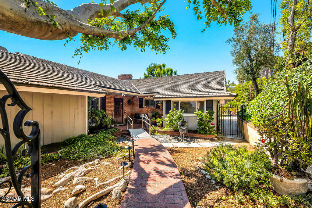 A rare architectural retreat in the heart of Studio City's most sought-after hillside enclave, just moments from the vibrant energy of Ventura Boulevard. This timeless ranch-style retreat offers a rare blend of privacy, space, and awe-inspiring views. Perched on 1.21 acres, this 4-bedroom (was 5 bedroom, 2 bedrooms have been opened to one large room), 2-bathroom home spans 2,495 sq. ft., with a 2-car garage, storage building, plus two distinct flat pads - providing room for expansion and inviting you to let your imagination run wild! This home showcases panoramic vistas of Universal City and beyond--captured from nearly every room. A gated paver driveway, framed by mature trees and lush ivy, leads to this tranquil sanctuary. Inside, classic character blends with endless potential to customize, from the wood-beamed ceilings and expansive picture windows to the charming brick and wood exterior. The floorplan includes a spacious living room anchored by a dramatic fireplace, a formal dining area with etched glass windows and a built-in china cabinet, and a remodeled kitchen with granite counters, a center island with bar seating, stainless appliances, and whisper-close cabinetry. The primary suite commands a private corner of the home with a fireplace, slider to the yard, and private bath. Three additional bedrooms, off the central den with a bar, offer flexibility for guests, office, or creative space. Step outside to discover a sparkling Pebble Tec pool and spa surrounded by natural beauty, rock-edged planters, and gathering spaces. The property also features a koi pond, multiple patios, and mature fruit and shade trees across a sloping hillside. Set in one of Los Angeles' most desirable neighborhoods, this Studio City location offers a rare blend of old-Hollywood charm and laid-back modern comfort. Tree-lined streets, mid-century architecture, and quiet cul-de-sacs create a peaceful residential feel, while just minutes away, Ventura Boulevard delivers acclaimed restaurants, stylish boutiques, cozy cafes, and weekend farmers markets. With commanding views, exceptional privacy, and a premier hillside address, this home embodies Studio City living at its best--distinctive, timeless, and iconic.