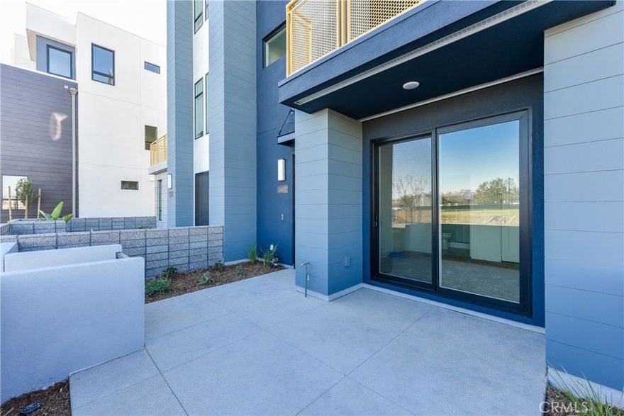 Location, Location, Location! This stunning contemporary townhome, built in 2022, is located in the most desirable spot within the Tustin Legacy community.  Just steps away from The District, you’ll find Costco, Whole Foods, Target, AMC Theatres, and an abundance of dining and entertainment options all within a one-mile radius. This nearly 2,000 sq. ft. home features 3 spacious bedrooms, 3.5 bathrooms, and a 2-car direct-access garage. The first floor offers a private guest suite ideal for visitors or extended family. On the second floor, the open-concept layout includes a bright great room, a gourmet kitchen with a large quartz island, stainless steel appliances, ample cabinetry, and a dining area that opens to a balcony. The third floor boasts a luxurious primary suite with a walk-in closet, and an additional bedroom suite. A laundry room is conveniently located on the third floor. Additional highlights include solar panels for energy efficiency, and recessed lighting. With easy access to major freeways and proximity to The Market Place, South Coast Plaza, UC Irvine, and John Wayne Airport, this home perfectly blends modern comfort, convenience, and premium community living.