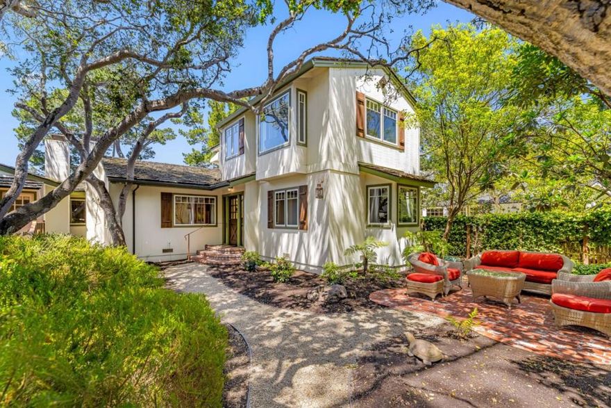 Just four short blocks to the beach and a level 5 block walk to town 'Casa Can't Believe it' is a rare treasure and delight hard to find. Set on a 6,000 SF lot a curved garden path leads you to a spacious yet cozy cottage classic in design. Within the 2,000 SF of living space there are three suites inside, nicely separated and positioned around a Great Gathering Room with high vaulted ceilings, Carmel stone wood burning fireplace and French doors and windows on all sides. Close at hand the kitchen and dining room are open and light, further extending the 'Great Room' feel where everyone can join in and be part of the fun. The first suite downstairs, almost a cottage unto itself, has Carmel stone fireplace, high vaulted ceilings and a private French door entrance and deck to the outside. Suite number two enjoys spacious garden and South facing views. Upstairs the generous primary suite features a cozy light and bright reading room with a corner bedroom that seemingly floats just under the canopy of trees and the sunlight. Finished in hardwood and stone floors, stone counters and plaster walls, the interior spaces and places will surely delight while the exterior garden and outdoor areas create a destination in their own right. Remodel plans available, ideal lot for an ADU,