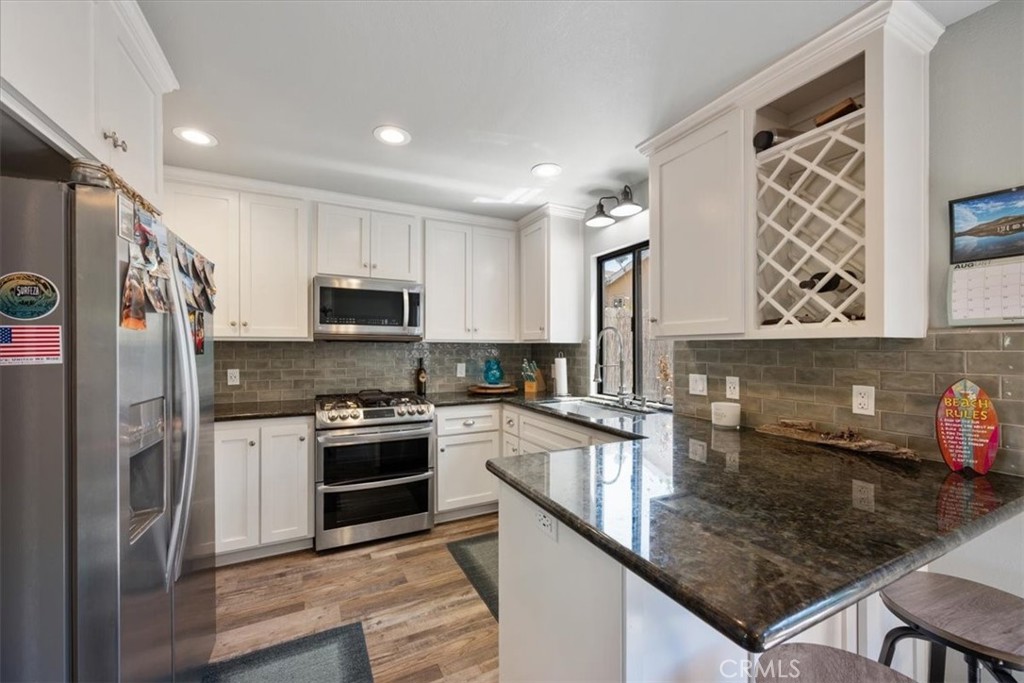 Experience the best of coastal living in this fully remodeled 2-bedroom, 2.5-bath Grover Beach condo—where every detail has been thoughtfully designed for style, comfort, and convenience.
Step inside to find a bright, reimagined kitchen with brand-new soft-close cabinets, gleaming granite counters, and stainless steel appliances (yes, there’s even a dedicated coffee bar with its own fridge). The layout has been upgraded for gas cooking, complete with a new stove, while fresh electrical work throughout the interior ensures modern reliability.
Both bedrooms boast full en-suite bathrooms—one with a luxurious steam shower—each styled in a calming, neutral palette. You’ll also find a cozy new fireplace insert with updated tile and hearth, vinyl plank flooring underfoot, and a tankless water heater for endless hot showers.
Smart storage solutions include a finished space under the stairs, while outside you’ll love the private stamped concrete patio with a gas line piped directly to your barbecue and outdoor fireplace area. A built-in side gate gives you direct access to the grassy area next to this desirable corner unit.
All this in a prime location just minutes from Pismo State Beach, Grover Heights Park, and the highly rated Lucia Mar schools. The community offers a sparkling pool, two parking spaces (one covered with a storage locker).
This isn’t just a home—it’s your personal slice of the Central Coast lifestyle.
