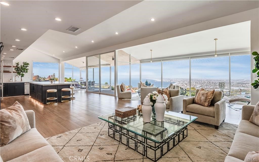 952 Via Del Monte offers an exceptional opportunity to live in a stunning, recently renovated 3,500+ sqft home, set on a sprawling 18,000+ sqft street-to-street lot. The residence boasts one of the most breathtaking and unobstructed views of the Queen’s Necklace, South Bay, Los Angeles, and the Pacific Ocean. This thoughtfully updated 4-bedroom plus an office/bonus room, 3-bathroom Palos Verdes Estates property is designed for both luxury living and effortless entertaining. The expansive open-concept living area is designed to maximize the awe-inspiring views, with a striking all-glass wall that brings the outdoors in. At the heart of the space, a chef's kitchen equipped with top-of-the-line appliances is ideally positioned for both convenience and style. The home's four spacious bedrooms are located on the upper level, with a convenient laundry area. The office, located just off the kitchen and dining areas, offers privacy and easy access to the pool, deck, and expansive views. From the moment you enter, you’ll feel the allure of this remarkable home—whether you seek a sanctuary for your family or an entertainer's paradise. This is a rare and perfect opportunity to experience unparalleled coastal living.