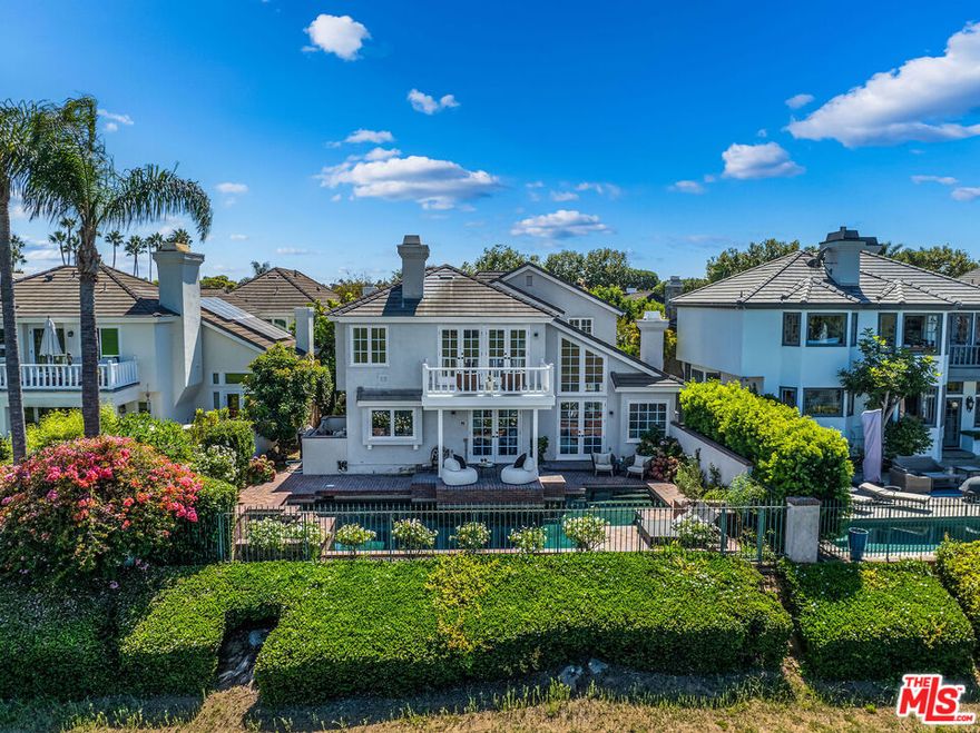 Home for the holidays! This stunning and rare offering is located in the prestigious Sea Cliff, a guard-gated community with privacy, views, and pool. This fully restored and thoughtfully renovated estate blends timeless character with modern living. With nearly 4,000 square feet, 4 bedrooms up (possible 1 down used as an office)  and 3.5 baths. This light-filled residence sits perfectly on the golf course, showcasing a sparkling pool, spa, and breathtaking vistas. Lovingly maintained by the same family for 38 years, this turnkey home is ready for its next chapter. Set back from the street, the entrance welcomes you with a grand walkway, lush greenery, and a calming fountain. Inside, soaring ceilings, a dramatic chandelier, and dark hardwood floors set the stage. The main level offers two distinct step-down living areas: one with arched doorways, a fireplace, a formal bar, and an interior courtyard with fountain; the other with a chic, vacation-inspired vibe and another fireplace. A formal dining room overlooks the living space, perfect for large gatherings, with French doors opening to the side yard. Also on this floor is a nanny's suite ideal for guests or multi-generational living, or an office (as shown) with built-ins, French doors, and a newly redone en suite bath. At the rear of the home, the chef's kitchen shines with white cabinetry, polished nickel fixtures, top-of-the-line appliances, and honed Calacatta marble countertops, overlooking the golf course and pool. A sunny breakfast area, spacious laundry room, powder room, and ample storage round out this level. Up the grand staircase, illuminated by a beautiful chandelier, the primary suite enjoys its own private wing. This serene retreat features a spa-like bath with a freestanding soaking tub and picturesque views, a Restoration Hardware double vanity with Signature fixtures, a large shower, fireplace, and two walk-in closets awaiting custom design. A private terrace offers yet another place to savor morning coffee or quiet moments. At the opposite end of the hall, three generous bedrooms provide flexibility for family, guests, or a lounge/playroom with access to another patio. These rooms share a spacious bathroom. Thoughtful details include a laundry chute from the upper level, delivering clothing directly to the laundry room below. The backyard is an entertainer's dream, tranquil and inviting with a pool, spa, fountains, and seamless indoor/outdoor flow overlooking  one of the best 18-hole championship golf courses in SoCal. Practical features include a three-car garage (two with direct access), driveway parking for six, and ample guest parking. Beyond the gates, The Huntington Club offers optional membership with tennis, pickleball, pilates, gym, and more. Just blocks from the beach and minutes to Downtown, top-rated schools, parks, oceanfront dining, and the iconic pier, this home places you at the center of the best Huntington Beach has to offer. A short drive takes you to other amazing coastal towns, Long Beach, Newport, Balboa, Lido Island and Laguna. A real show stopper, everyone that comes by, loves this home. You will too!