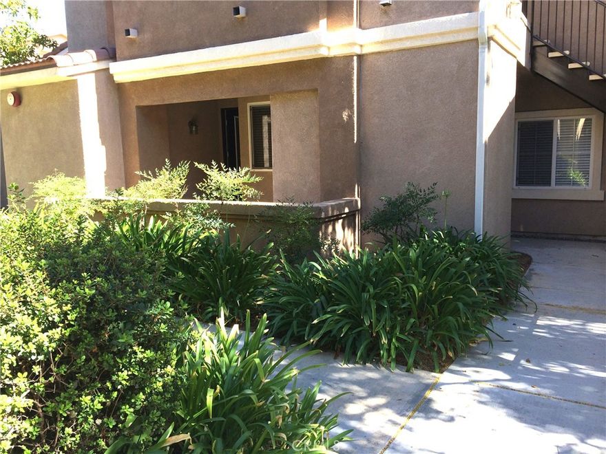 This lovely ground floor condo in The Reserves at Madison park has an attached 1-car garage with direct access into the unit plus an assigned carport. Interior has wood laminate flooring throughout, ample laundry room with washer and dryer, split floorplan with spacious living room, dining area, and built-in computer desk/work area off the kitchen.  Living room boasts a cozy fireplace and opens to a covered patio. Indoor utility/storage room.  Walk-in closets in both bedrooms, ceiling fan in primary bedroom, new faucets and toilets in both bathrooms.  Community amenities include pool, spa, clubhouse, picnic area, playground, racquetball court and fitness center. Owner pays for HOA fees (including trash removal), tenant pays for electric, gas, water, sewer, cable/internet. Conveniently located, near freeways, shopping, dining and entertainment.