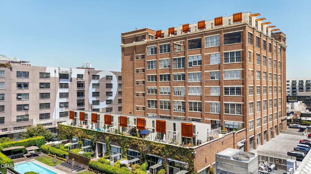 Step into an exceptional urban sanctuary at the Biscuit Lofts in the Arts District--a true artist's mega loft that harmonizes industrial charm with modern elegance. Sprawling across 2,400 square feet, this unique space boasts soaring 17-foot ceilings, creating a voluminous atmosphere perfect for creative expression and dynamic living. Biscuit Lofts is on the National Register of Historic Buildings, and owners have the benefits of the Mills Act.Designed for the discerning individual, this loft features two luxurious bathrooms and a versatile open layout adaptable to your personal needs, including the opportunity to expand a second bedroom. The seamless transition between indoor and outdoor living extends to two private outdoor spaces totaling nearly 1,200 additional square feet, offering serene retreats with panoramic cityscape views--ideal for entertaining or quiet reflection.Residents of this prestigious midrise enjoy a wealth of premium amenities, including a full-time concierge service, a 75-foot pool with a BBQ area, and a subterranean parking garage. This unit comes with two assigned parking spaces, both with EV hookups in the secured garage. Security is paramount, with a robust security system and gated entry ensuring peace of mind.Downtown LA's Arts District is the heart of the vibrant culinary scene in Los Angeles with acclaimed restaurant Camelia on site and endless world-class restaurants mere steps away. Embrace the epitome of style and sophistication in the heart of Downtown Los Angeles' Arts District.