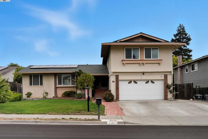 Desirable Silvergate neighborhood with TOP-rated schools. 5 bedrooms and 3.5 bathrooms with all engineered hardwood floors. The downstairs has 1 bedroom, a full bathroom, and another half bathroom perfect for guests, parents or a private home office. 4 bedrooms and 2 full bathrooms are upstairs. The backyard is filled with mature fruit trees. This home offers quick access to shops, dining, BART, and both 580/680 freeways—an ideal combination of convenience, community, and move-in readiness. Solar is leased.