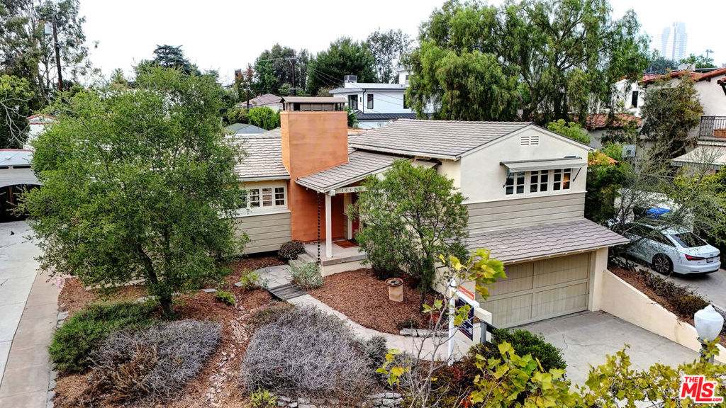 10509 Blythe Ave Cheviot Hills - Exuding masterful architecture and subtle sophistication, this 3-bedroom, 3-bath plus office/study residence embraces indoor-outdoor living at its finest. The thoughtful floorplan flows around a central courtyard patio, opening into masterfully designed native plant gardens. Interiors are filled with natural light and include a formal living room with vaulted high ceilings and fireplace, an elegant dining room, and a country rustic kitchen highlighted by a vintage O'Keefe & Merritt stove. The spacious primary suite features a refined bath retreat and its own dedicated sitting room/study overlooking the gardens. Expansive glass doors throughout provide seamless access to outdoor spaces ideal for al fresco dining and entertaining. An attached garage with direct access adds convenience. Ideally located near Rancho Park, UCLA Research Park, Westwood Greenway, Expoline, Century City, golf, shopping, dining, and within the highly sought-after Overland Elementary School district.