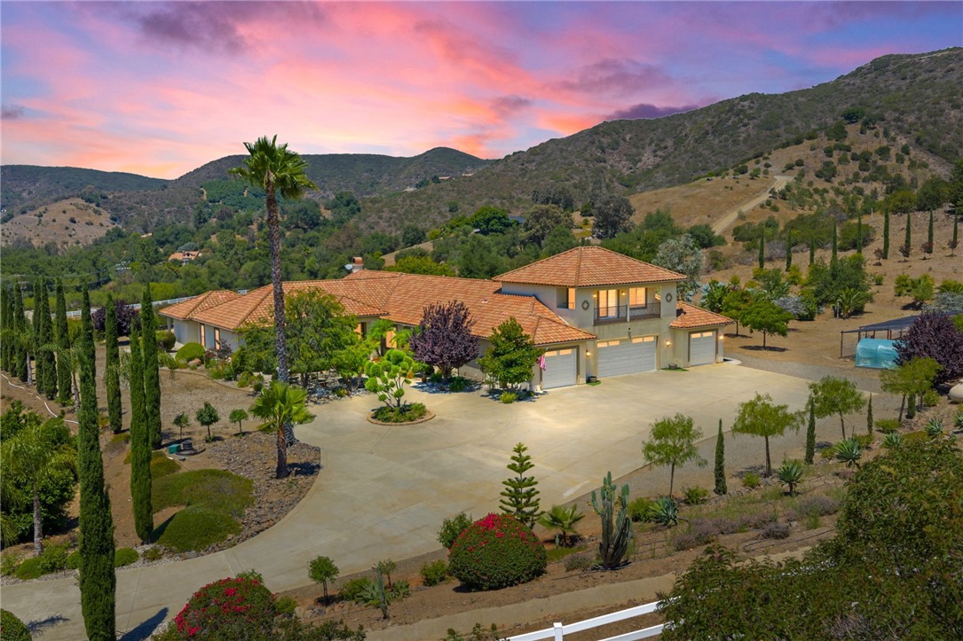 This Magnificient Mediterranean Estate is located in the prestigious are of De Luz - often called Millionaire's Row - Adjacent to the Santa Rosa Plateau and just 10 minutes from Interstate 15! Very Private - Located on approximately 11 acres of gentle land, with numerous fruit trees and flowers, fenced garden areas, chicken coop, and perfect to plant additional vineyards, citrus, or for Equestrian uses. Entering the elegant property through the gated entrance, up the gently curving driveway lined by roses, you will be happy to be home! The open floor plan has approximately 7,445 square feet, with 5 bedrooms and 4 baths on the main floor, plus a large office/gym/theatre room upstairs, with a bathroom & shower upstairs! The over sized 1,800 sf - 4 car garage plus workshop area, offers room for any vehicle, and plenty of storage - plus there are 2 separate 200 amp, 3 phase electrical panels with 220 v. outlets throughout the garage. The newer Solar system will reduce your electric costs substantially!
The gourmet kitchen offers double granite islands, Profession Chef's appliances equipped with built-in Thermador and GE Monogram stainless appliances, huge walk-in pantry, separate breakfast nook with views, and is open to the Family Room with vaulted ceilings and fireplace. The Handmade tumbled marble mural backsplash and cast stone moldings accentuate the vineyard theme!
The Primary Bedroom includes two walk-in closets, large vanity, Jacuzzi tub, and large walk-in shower. and the other bedrooms offer large closets and adjacent bathroons. The outdoor kitchen/BBQ is a perfect area for enjoying the evening sunsets. There is an oversized Laundry Room plus Utility Room which offer so much extra storage! Additional features: Whole house central vacuum, completely wired for Cat 5 high speed networking.