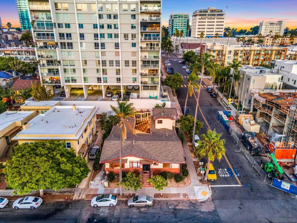 Incredibly rare mixed-use property located at the prestigious corner of 1st Ave and Maple St, just steps from Balboa Park, Mister A’s, and surrounded by some of San Diego’s most beautiful historic homes. This trophy asset sits in the heart of Bankers Hill and offers a unique combination of commercial and residential zoning—allowing for unmatched flexibility and long-term upside. The front corner unit, which resembles a classic home, is leased to a professional office tenant under a long-term agreement with built-in annual rent escalations. The remaining four units are a mix of Airbnb and long-term residential tenants, all of which have been extensively remodeled. Two units were completely rebuilt from the ground up in 2024. Major upgrades include all-new electrical, plumbing, insulation, HVAC systems, new electrical meters, and a state-of-the-art fire sprinkler system throughout. Each residential unit has been professionally designed and furnished, offering strong rental performance. The upper unit enjoys bay views, and all tenants share access to a beautifully landscaped common courtyard. With dual street frontage on both 1st Ave and Maple St, this is a true pride-of-ownership asset with rare mixed-use appeal in one of San Diego’s most coveted neighborhoods.