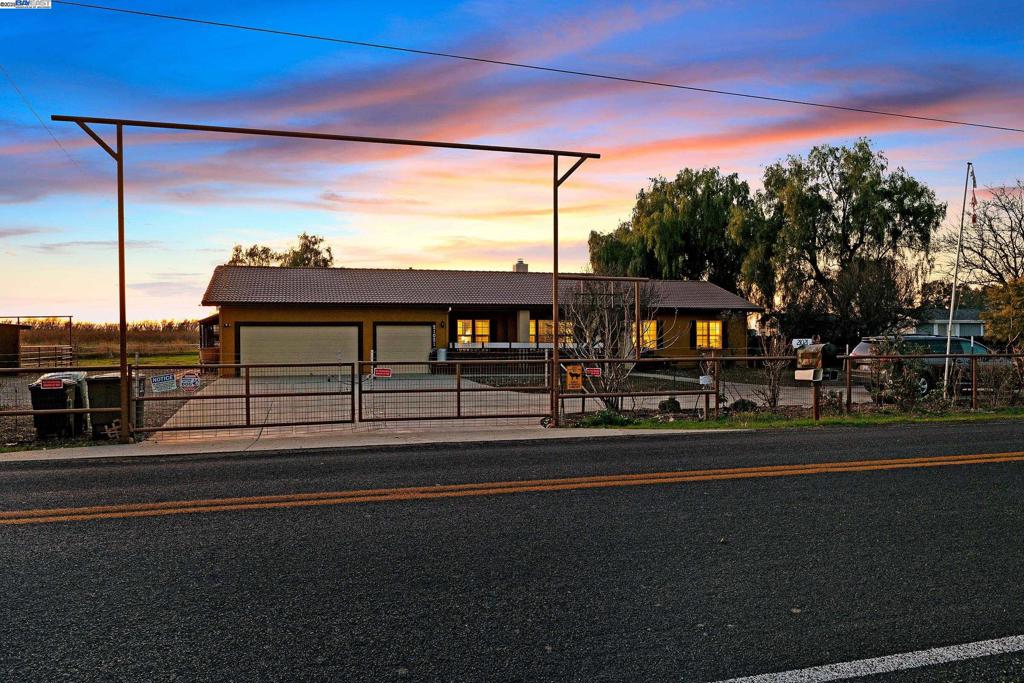 This is it! Views! Stunning hobby farm with 1.5 flat acres that includes 4 stall pole barn with tack room and corrals, pasture area, covered patio, views for miles room for animals and so much more. Custom single-story home was built in 1998 and features 4 spacious bedrooms, 2.5 bathrooms, 9' ceilings, gas cooktop, hardwood floors, dual pane windows, newer AC, plantation shutters and a sweeping driveway. Front faces easterly directions and rear of property enjoys breathtaking sunsets in the west. Don't miss this opportunity!