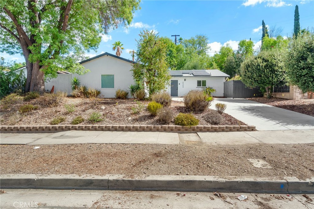 Fully remodeled 4-bed, 2-bath home in sought-after Woodland Hills. This modern retreat features high ceilings, recessed lighting and new waterproof luxury vinyl plank floors throughout. The open living area centers around a sleek fireplace and flows into a chef’s kitchen with quartz countertops and stainless steel appliances with smart Wi-Fi features. The primary suite offers a large walk-in closet, backyard access and a spa-style bath with dual vanities, walk-in shower and standalone soaking tub. Three additional well-sized bedrooms are located on the other side of the house, surrounding a second luxurious bathroom. Enjoy sunny days by the pool in your private backyard oasis, and add outdoor dining and tropical landscaping for your California dream home. Upgrades include new copper plumbing, upgraded electrical panel (2014), Tesla solar panels, dual-pane windows, finished two-car garage with epoxy floors, newer HVAC and water heater. Conveniently located near the 101, Westfield Topanga, Kaiser and Warner Center - this move-in-ready home blends style, comfort and location.