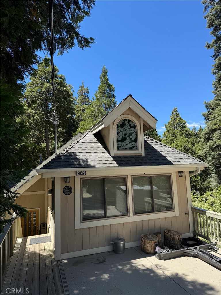 Cozy cabin built in 2005 with a picturesque setting. This spacy cabin has level parking pad for several cars. The cabin has three patios with views. The garage is used as a game room with a pool table and foosball table for entertainment.
