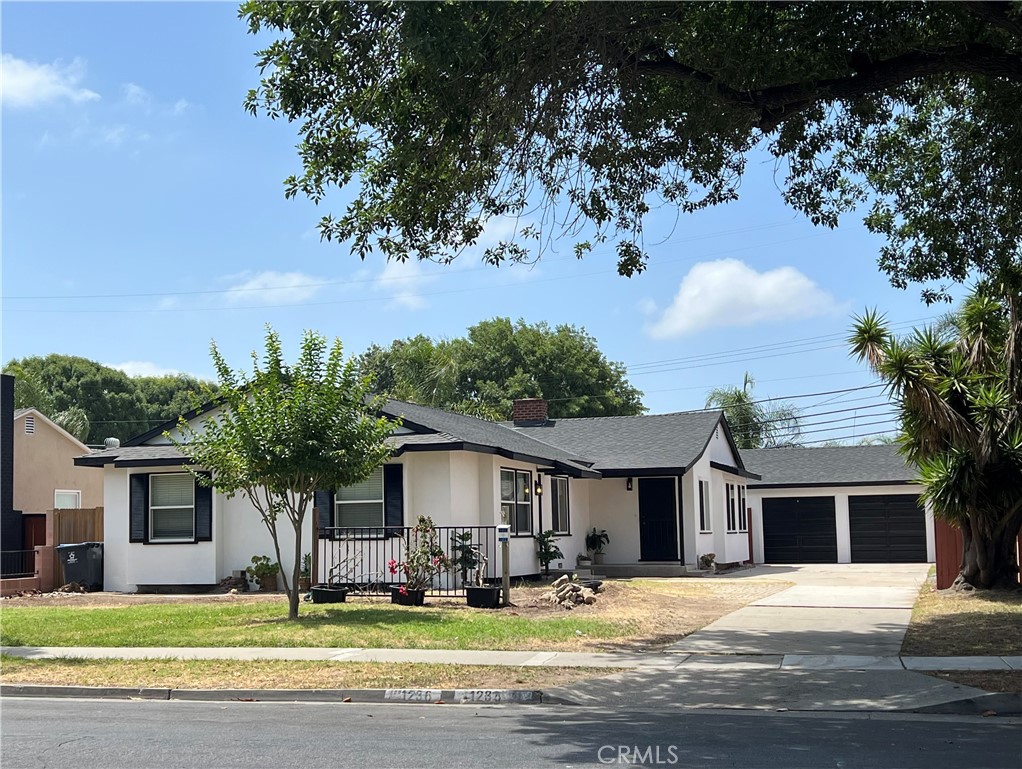 Welcome to this beautifully remodeled front unit of a charming duplex located in the prestigious West Floral Park neighborhood—one of Santa Ana’s most sought-after communities. This 2-bedroom, 1-bathroom home has been thoughtfully updated with new kitchen counters, new cabinets, a brand-new stove, modern fixtures, and fresh interior paint throughout. Enjoy new flooring and windows that bring in natural light and comfort. The kitchen includes laundry hookups for added convenience. The property features a long driveway with ample parking space, plus access to one of two garage bays, perfect for storage or additional parking. With abundant street parking and a peaceful, tree-lined setting, this home offers both convenience and serenity.