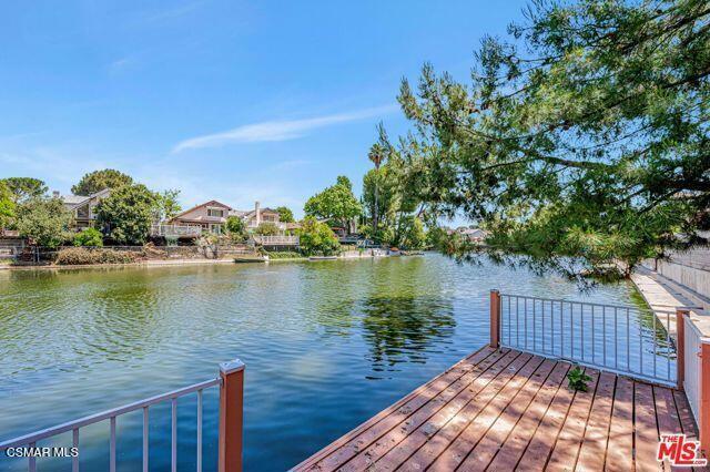Awesome mountain and lakefront retreat-like getaway awaits! Majestic lake and mountain views!! This spacious and expanded Lakefront Home is right on the water! Beautifully maintained 3 bed 3 bath nearly 1900 square foot lakefront retreat offers BONUS SQUARE FOOTAGE in the added playroom / loft with Lake Views and perfect for kids! Enjoy comfort, luxury, and seamless indoor /outdoor living. Nestled in the highly desirable Lake Lindero community and in the heart of Agoura Hills, this home features its own private boat dock, ideal for sunset cruises, fishing, or enjoying an evening cocktail. If this isn't enough, try your hand at kayaking or stand-up paddle boarding. Inviting gated front courtyard, provides both privacy and charm. Inside you will find an spacious and open floor plan with gourmet kitchen, dining, living room with cozy fireplace and elegant French doors that open to a newer wood deck, perfect for entertaining or relaxing while taking in the stunning lake views. Warm and inviting. light and bright. Built-in BBQ perfect for outdoor gatherings. This home is equipped with PAID OFF SOLAR offering energy efficiency and VIRTUALLY NO MONTHLY BILL! Enjoy the 16-acre lake, top-rated schools, and upscale shopping, and only 15 minutes to the beaches of Malibu, this home offers both seclusion and convenience. Lake Lindero Membership includes 4 well-lit tennis courts, community pool, pickle ball, restaurant and optional 9 hole golf course. Professional photos to be added 09/24!