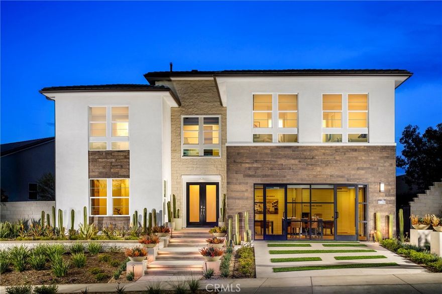 Stunning 5-bedroom and 5.5-bath fully furnished Toll Brothers model home in the heart of FivePoint Valencia. Designed for modern luxury and effortless indoor-outdoor living, this contemporary residence features soaring two-story ceilings, a dramatic great room with floor to ceiling windows, floating staircase with glass railing, and expansive stacking doors that open to a resort-style backyard with pool, fire feature, built-in BBQ, and covered lounge/dining area. Chef’s kitchen includes an oversized quartzite waterfall island, premium Wolf & Sub-Zero appliances, and walk-in pantry. First-floor multi-gen suite offers a private retreat with its own living area and full bathroom. Upstairs loft overlooks the great room, and each secondary bedroom features its own en-suite bath and walk-in closet. The primary suite is a private sanctuary with wood-paneled ceiling, private deck, dual closets, and a spa bath with Calacatta Gold marble floors, floating tub, and walk-in shower. Located in a vibrant master-planned community with top-rated schools, trails, and parks.