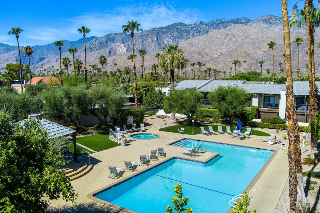 IIdeal desert living is waiting for you at this charming, single-story condo in Rancho La Paz. Located in highly sought-after South Palm Springs, this 2-bedroom, 2-bath end unit offers 1,174 square feet of spacious comfort. With no neighbors above or below, you'll enjoy privacy in this serene setting, just steps away from the community's largest pool and your covered parking spot. The interior features vaulted wood ceilings in the living room and primary bedroom, creating an open and airy feel. Both bedrooms offer en-suite baths, and the primary boasts a large walk-in closet. Step outside to a generous private patio offering mountain views and a separate entrance. The community amenities in Rancho La Paz enhance your desert lifestyle with 3 pools, spas, tennis / sport courts, and gated community access, all contributing to a true resort-style experience.