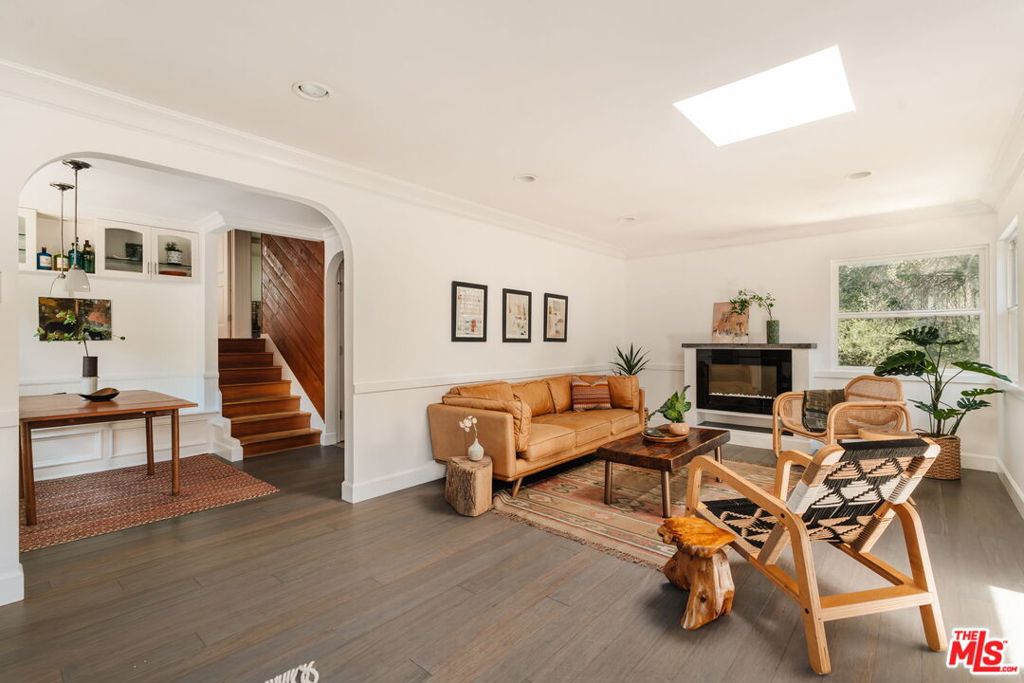 Tucked just off Topanga Canyon Boulevard and only a few hundred yards from Topanga State Park, this 4-bedroom, split-level home offers laid-back canyon living with style and convenience. The spacious Mangaris wood deck out front is perfect for gathering with friends, dining al fresco, or simply soaking in the peaceful surroundings. Inside, the cozy living room features a modern fireplace and bamboo flooring. The remodeled kitchen with Caesarstone countertops, stainless steel appliances, and travertine tile floors, flows into a large custom-built breakfast nook with built-in storage. Upstairs are two bright bedrooms and a full bath; downstairs, two additional bedrooms, another full bath, and a laundry area that opens to a flat backyard, shaded by mature oaks and a rear deck perfect for lounging. Thoughtful upgrades include a newer roof, dual-pane windows, and updated siding. Plenty of off-street parking for four or more cars.