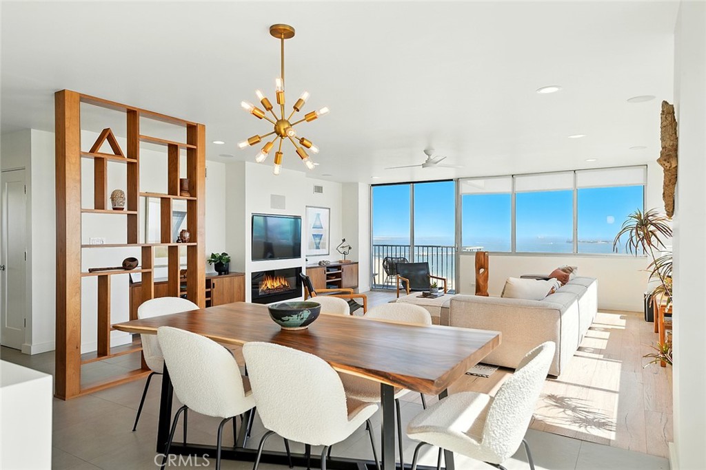 The crown jewel of Long Beach living, panoramic ocean views, timeless design, and unmatched exclusivity. Welcome to The Galaxy, a historically renowned Mid-Century Modern masterpiece and one of the city’s most architecturally significant high-rises. With only four residences per floor and no shared interior walls, the building offers a rare blend of architectural pedigree and serene living in a prime coastal location between Downtown Long Beach, Belmont Shore, and Retro Row. Perched high above the shoreline, Residence 1320 delivers commanding 270° unobstructed views stretching across the coastline, Catalina Island, and the city skyline. Expansive walls of glass flood the home with natural light, perfectly framing breathtaking vistas from nearly every room. The primary suite is a private retreat, showcasing sweeping ocean views and direct balcony access. Its remodeled en-suite bathroom is filled with natural light and finished with modern double sinks, a sleek vanity, rainfall shower, and soaking tub, creating a spa-like escape at home. Sparing no expense, the floor plan was expertly reconfigured for a true open-concept layout. Designed to honor its Mid-Century roots while introducing every modern convenience, the home features an open kitchen with walnut cabinetry, quartz waterfall counters, stainless steel appliances, and striking designer lighting. Additional upgrades include white oak floors, recessed lighting, a digital fireplace, in-unit laundry, smart-home integration, custom built-ins, and UV-protected windows with built-in roller shades. Entertainment enthusiasts will appreciate the built-in 5.1 channel surround sound in the living room, bringing movie nights and gatherings to life. Unique touches such as a concealed pop-up bedroom TV and a fireproof safe further set this residence apart. Living at The Galaxy means more than a home , it’s a lifestyle. Residents enjoy secure underground parking, a dedicated storage unit, full-time management and security, and a landscaped courtyard with BBQs for entertaining. Step outside to Bluff Park, the oceanfront bike and jogging paths, and endless dining and shopping options at nearby 2nd Street, Shoreline Village, and The Pike. At 2999 E Ocean Blvd #1320, luxury, architecture, and coastal living converge, offering a one-of-a-kind opportunity to own a piece of Long Beach history with some of the most panoramic ocean views the city has to offer. Welcome home.