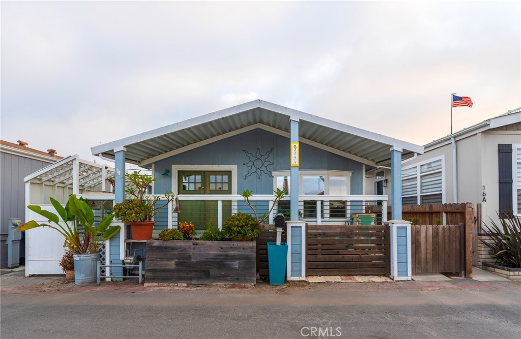 Fantastic chance to literally live cross the street from the famous Surf City Beach and Ocean with a stones throw from dozens of restaurants, bars, shops and so much more! This unit has a metal spiral stairway to the upper deck with endless views of Catalina and the sandy beach and ocean! It is truly incredible. Where can you live this close to the beach in such a beautiful house for this low of a cost???!!! Community heated pool year-round, clubhouse and guest parking all included in the Cabrillo Waterfront Village land lease. Several upgrades have been made to bring this home up to date! Very comfortable open floor plan with entry living area and kitchen and all 3 bedrooms and the 2 bathrooms located toward the back. Great lighting throughout the place. There is a washer and dryer side-room connected near the kitchen in the breezeway to exit the side yard that leads to the back rooftop deck and they can also be included as well as the refrigerator in the purchase. Many upgrades throughout! Freshly painted and move in ready! The front patio area is serene and quiet and has great potential for morning and evening relaxing. The upper roof-top deck is so amazing and a great addition to the already beautiful home and location. Land lease amount will be $3,461 for the new buyer. Includes pool, Spa, BBQ and Gym as well as water, sewer and trash. Washer, Dryer, refrigerator and certain furniture can be part of the sale as well.