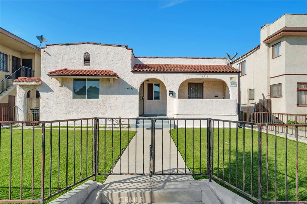 Welcome to a rare opportunity in the heart of Los Angeles — a move-in ready Spanish-style multifamily home where you can live comfortably in a spacious 3-bedroom unit while your tenants help cover the mortgage. Perfect for an owner-occupant, this property combines the charm of a true home with the benefits of built-in rental income. The main residence features an open-concept living area with an upgraded kitchen, three generous bedrooms, a large full bath, and a convenient guest half bath. You’ll also enjoy exclusive use of the two-car garage. The two additional units provide steady income from day one: A well-kept 2-bedroom unit with a reliable long-term tenant. A private studio with full bath and kitchenette, tucked away with its own rear entrance. Together, these units bring in $3,100 per month — meaning you can live in your dream home while easing the cost of homeownership with dependable rental income. Recent upgrades include new laminate flooring, dual-pane windows, copper plumbing, ABS sewer lines, and low-maintenance artificial turf that keeps utility costs down. With two extra parking spaces in the back, every unit enjoys the convenience of off-street parking. Looking ahead, the property also comes with plan check approved plans for two ADUs — giving you room to expand, create more income, or design additional living space for family. Located in vibrant Mid City, you’ll be at the center of it all: Downtown, Hollywood, Beverly Hills, Culver City, The Grove, Koreatown, LACMA, SoFi, and the beaches are all just 15–30 minutes away. This is more than a home — it’s a lifestyle and a long-term financial strategy. You’re looking at the ultimate “house hack” in LA! Live here, and let the property catapult you toward financial freedom.