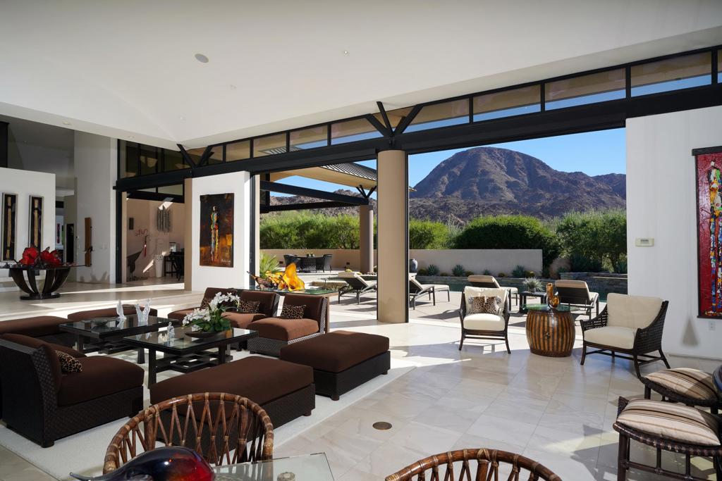 Dramatic and extraordinary Stewart Woodard architectural design within The Reserve! Perched on an elevated lot and tucked within nature's rock sculptures, this warm and elegant custom residence displays remarkable privacy and panoramic mountain views. A gentle winding stairway leads you to the stunning terrace and formal entry into the expansive living room that is an entertainer's dream, including high ceilings and windows that capture light and views in every direction. Quality construction and custom design elements and furnishings compliment the contemporary style throughout this 8,010 sq. Ft. home. The open family room, gourmet kitchen and dining areas are combined for intimate living and gathering complete with fireplace. The serene master retreat, 2 guest suites and an office are in the main home, while a detached casita is a welcoming space for family and friends. An exceptional pool, spa and outdoor kitchen are surrounded by a generous patio, a complete oasis during the day or evening to take in the commanding desert scenery. A 4-car garage is on the lower level and offers an elevator for convenience to access the main residence. See how beauty and function come together in this work of art in the desert!