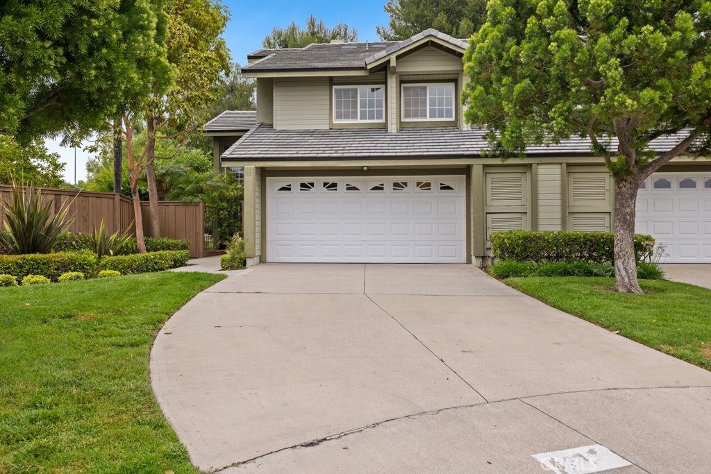 Welcome to 59 Carriage Hill Lane in the desirable Indian Creek community of Laguna Hills. This beautifully maintained home features the largest backyard in the entire community on a 6000 square foot lot! Enter the gated front entrance to the spacious living room with soaring vaulted ceilings and a charming brick fireplace, seamlessly flowing into the formal dining room—ideal for entertaining. The adjacent kitchen is well-appointed and opens to a cozy family room with sliding glass doors that lead to a lush backyard oasis, complete with a brick-lined patio and green lawn. Enjoy the beautiful 4th of July fireworks directly from the backyard. A convenient powder room and full-size laundry room offer direct access to the two-car attached garage. Upstairs, the expansive primary suite boasts vaulted ceilings, a private en-suite with dual sinks, and ample closet space. Three additional bedrooms and a full hall bathroom complete the upper level. Additional upgrades include new recessed lights, new outlets and switches, fresh paint throughout and newer roof replaced by the HOA just three years ago. With its thoughtful layout and expansive outdoor space, this home blends comfort, functionality, and style in a sought-after neighborhood.