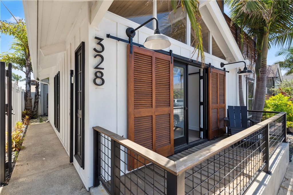Bright, open and wonderfully private, this high-end reimagined Newport Shores home offers the prized advantages of an address just moments from gorgeous beaches, the piers of Newport Beach and Huntington Beach, shopping, restaurants and parks. A Modern Coastal Farmhouse vibe elevates curb appeal, while a front patio and a shaded side entry patio enrich indoor/outdoor living. Welcome guests through a classic Dutch door to a double-height foyer with a sleek circular staircase and direct access to a dining room that opens to the side yard. A high coffered ceiling crowns the living room, where entertaining friends and loved ones will be a delight thanks to a stylish linear fireplace, floating shelves, built-in cabinets, and a French door that opens to the private entry patio. Four bedrooms and three baths are featured in approximately 2,454 square feet of fashionably appointed living space, which includes a second-level primary suite with vaulted ceiling and ensuite bath. A hallway bridge links the suite to a spacious loft with french doors that open to a magnificent deck featuring a greenhouse-inspired open-air cover and ample room for stargazing, cocktail parties and refreshing relaxation. Premium appointments distinguish the kitchen, and wood flooring, chic lighting, shiplap wall and ceiling finishes, and a crisp white color theme enhance this move-in-ready showplace. Residents of Newport Shores are treated to a sought-after west Newport Beach location that is embraced by a scenic canal and home to a private beach with sand volleyball court, a swimming pool, clubhouse, tennis court, barbecue area and Newport Shores Park. Newport Harbor, Balboa Island, Fashion Island, and extraordinary schools are all only minutes away.