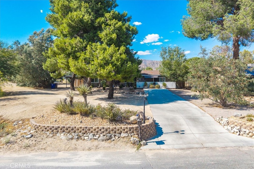 Welcome to Your Dream Home in Morongo Valley!
This stunning 4-bedroom, 2-bathroom charmer nestled is on nearly a half-acre lot with majestic Mountain View’s! Ideally located just minutes from the convenient shopping, dining, and schools of Yucca Valley, and a short drive to the glamour of Palm Springs, this home promises an unbeatable lifestyle!
The definition of “true pride of ownership” coming to life with a beautifully landscaped yard adorned with vibrant flowers,cacti,and desert flora, all framed by mature pine trees and stunning mountain vistas!
Inside this spacious 1,632 square-foot gem, where you’re welcomed by a well designed floor plan. Tasteful tile flooring, dual-pane windows, and elegant crown molding accents set the stage for modern living. The entertainer’s dream kitchen seamlessly flows into the dining and living areas, making it easy to prepare gourmet meals while staying engaged with your guests. With upgraded granite countertops, ample cabinetry, a stunning mosaic backsplash, recessed and pendant lighting, and sleek stainless steel appliances, this kitchen is a culinary enthusiast's paradise!
Just past the dining area, discover the cozy den, featuring plush carpet, a stylish custom light fixture, more crown molding, and a sliding glass door that floods the space with natural light.
Each guest bedroom is generously sized, complete with closets, ceiling fans, custom shelving, and plush carpeting. The full guest bathroom offers a relaxing tub/shower combo, tile flooring, a stylish vanity w/mirror!
The primary suite, boasting two closets, exquisite crown molding, carpet, and a ceiling fan to keep you comfortable. The private bathroom has been renovated with a stunning vanity, elegant mirror, walk-in shower, tile flooring, and an additional bonus closet! Step through the sliding glass door to your own exquisite private patio, complete with a sail shade—perfect for morning coffee!
Venture into the backyard and prepare to be amazed! Enclosed by wood privacy fencing, the meticulously manicured landscape features lush green grass, potted plants, desert flora, and cacti, all surrounding a covered patio—ideal for hosting unforgettable outdoor gatherings! Embrace the ultimate desert lifestyle with a refreshing dip in the large above-ground pool!
Additional highlights include a brand-new HVAC system, an upgraded evaporative cooler, a spacious freestanding shed for storage, a covered carport, an indoor laundry room/pantry, and so much more!