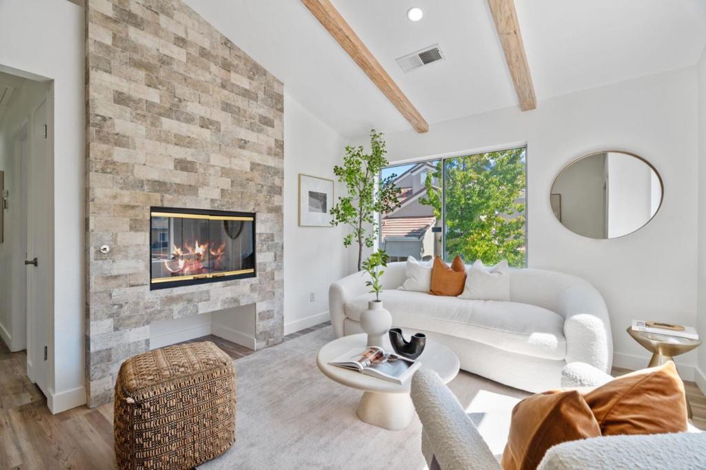 Rarely available corner unit with 2 parking spots in the highly desirable Renaissance community of North San Jose-upgraded and move-in ready! Thoughtful upgrades include new flooring, remodeled bathrooms, premium appliances, smart-home switches, and a dramatic ceiling-to-floor fireplace with open beam ceiling. The bright, open layout features a modern kitchen with recessed lighting, ample cabinetry, and generous storage. Enjoy peace and quiet with no neighbors below the unit. For weekend fun, head to Guadalupe Trail or Ulistac Natural Area for scenic walks, bike rides, or birdwatching. Resort-style amenities include a pool, spa, and lush green spaces. Centrally located with quick access to major tech employers, highways, VTA light rail, Levis Stadium, and Great America plus walking distance to shops. Served by the award-winning, newly built Agnew School Campus. Dont miss this opportunity!