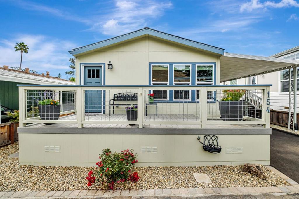Located in one of the most sought-after 55+ rent controlled communities, this delightful recently upgraded 2 bed/2 bath home blends functionality with style with one of the best views in the park! Space rent only $587 and no HOA $. The property offers views of the lovely hills from the front porch and living room where you can enjoy the llamas, horses and cows graze on the hillsides. The dining area and kitchen with beautiful quartz countertops and island with open living room are perfect for entertaining family and friends or just relaxing at the end of the day. The large primary bedroom features a full bath and walk-in closet. Add'l upgrades: paved tandem driveway, roof replaced 2022, exterior drainage systems. Community amenities include a clubhouse with pool table, book and puzzle libraries where residents can gather. Relax at the secluded and quiet heated pool or jump in for some exercise or just a dip. Park also features a dog park, RV parking and car washing station and is just minutes from 41st Avenue shopping, local beaches, hospital and public transit. Whether you're seeking a full-time residence or a peaceful coastal escape, this home offers the perfect blend of comfort and convenience.
