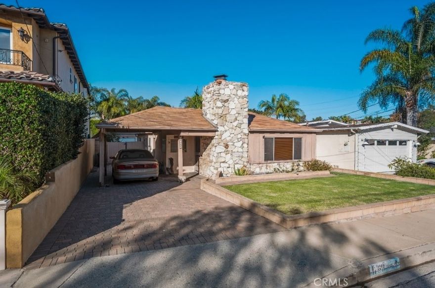 A rare Manhattan Beach opportunity. This inviting single-level home features a thoughtfully designed, partially open-concept kitchen adjacent to a living room with a classic wood-burning fireplace, two bedrooms, and two bathrooms. The spacious primary suite boasts dual walk-in closets, one being cedar-lined. One of the bathrooms is enhanced with a jacuzzi bathtub, ideal for relaxation.

Additional highlights include an oversized two-car garage located at the rear of the property and a long, beautifully crafted paver driveway offering abundant off-street parking both in front of and behind a secure gate, which enhances the home’s curb appeal. The private backyard is ideal for entertaining or unwinding, complete with a pool and diving board, and offers exceptional potential to customize, expand, or build new in a prime coastal location near beaches, schools, shopping, and dining