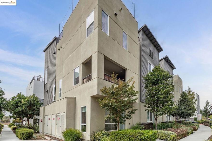 Modern 3BD/4BA end-unit townhome in Marina Bay’s desirable NOMA community. Built in 2018, this light-filled, multi-level home offers 1,739± sq ft of open-concept living with $75K in upgrades, including automated blinds, Café appliances, Monogram fridge, and a premium security system. Spacious living room flows into a sleek kitchen—perfect for entertaining. Enjoy a private rooftop deck with partial Bay views, ideal for outdoor dining or relaxing sunsets. The 2-car garage features epoxy floors and custom built-ins. Prime location near Bay Trail, parks, and Richmond Ferry, with easy access to Oakland, Berkeley, and San Francisco.