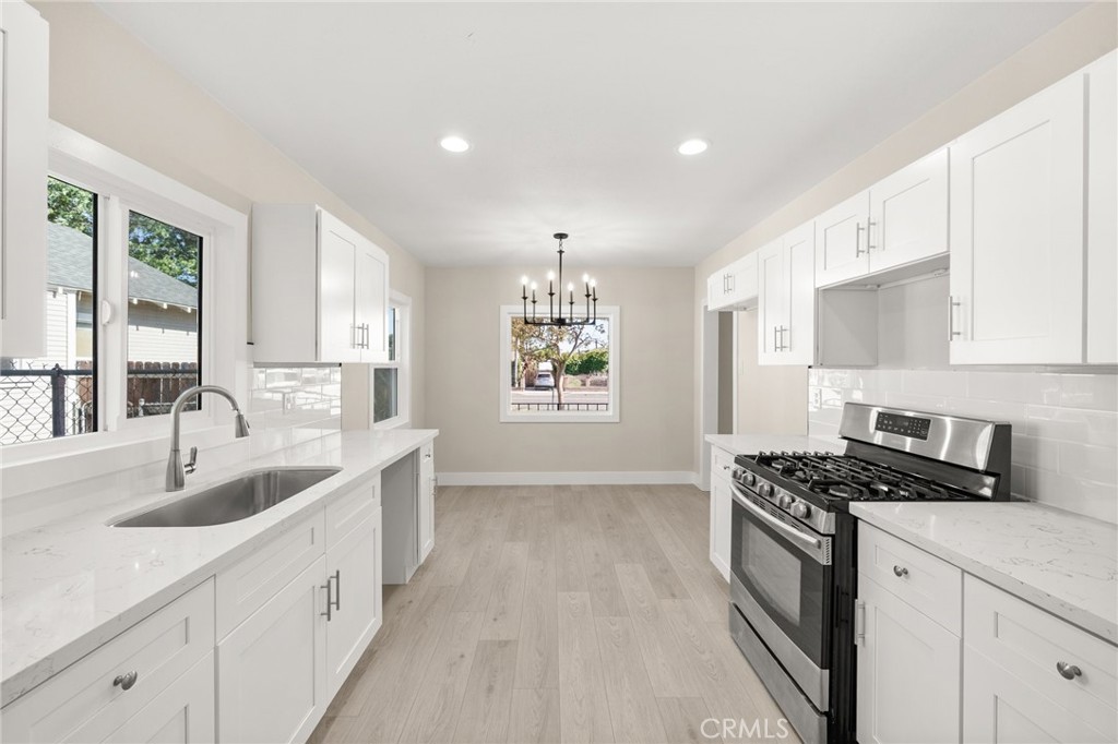 Renovated Spanish-Style Charmer in the Heart of Pomona!
This beautifully updated 3-bedroom, 2-bathroom home blends timeless architecture with modern finishes. Situated on a spacious corner lot, this Spanish-style stunner features a classic red clay tile roof, a fresh monochromatic exterior paint scheme, and a welcoming front porch perfect for relaxing outdoors. A large bay window fills the living space with natural light, creating a warm and inviting atmosphere.
Step inside to discover a tastefully renovated interior boasting a soothing greige color palette, arched doorways, and a statement fireplace with an elegant mantle. Enjoy all-new flooring, baseboards, recessed lighting, and interior doors throughout -- providing a truly move-in-ready experience.
The remodeled kitchen offers new cabinetry, sleek countertops, and a stylish subway tile backsplash. The attached dining area is enhanced by a gorgeous chandelier, perfect for entertaining or enjoying every day family dinners. Just off the kitchen is a convenient laundry room that leads to a spacious, covered patio that extends to the detached garage—ideal for gatherings or peaceful outdoor living.
Fully fenced for added privacy and peace of mind, the generous front yard offers a secure space for families to play and relax. Centrally located to the 10, 60, and 71 FWYs, don’t miss the chance to own this unique blend of classic charm and modern comfort in one of Pomona’s most desirable neighborhoods!