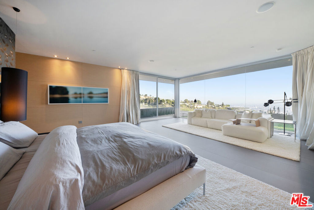 Nestled on Trousdale Estates' hillside, this Beverly Hills jewel presents an awe-inspiring 180-degree vista panoramic view stretching from downtown LA to the enchanting Catalina Island, adored from the infinity edge pool/jacuzzi and the inviting Primary suite within the 5-bedroom modern villa. Steve Hermann's redesign prioritizes harmonious indoor-outdoor integration and abundant natural light. This residence embodies luxury intertwined with modern conveniences, impeccably suited for its prestigious setting. The property features an expansive yard, Poliform kitchen/closets, Crestron home automation, Vantage lighting, and top-tier finishes, culminating in an emotionally compelling masterpiece of flawless design.