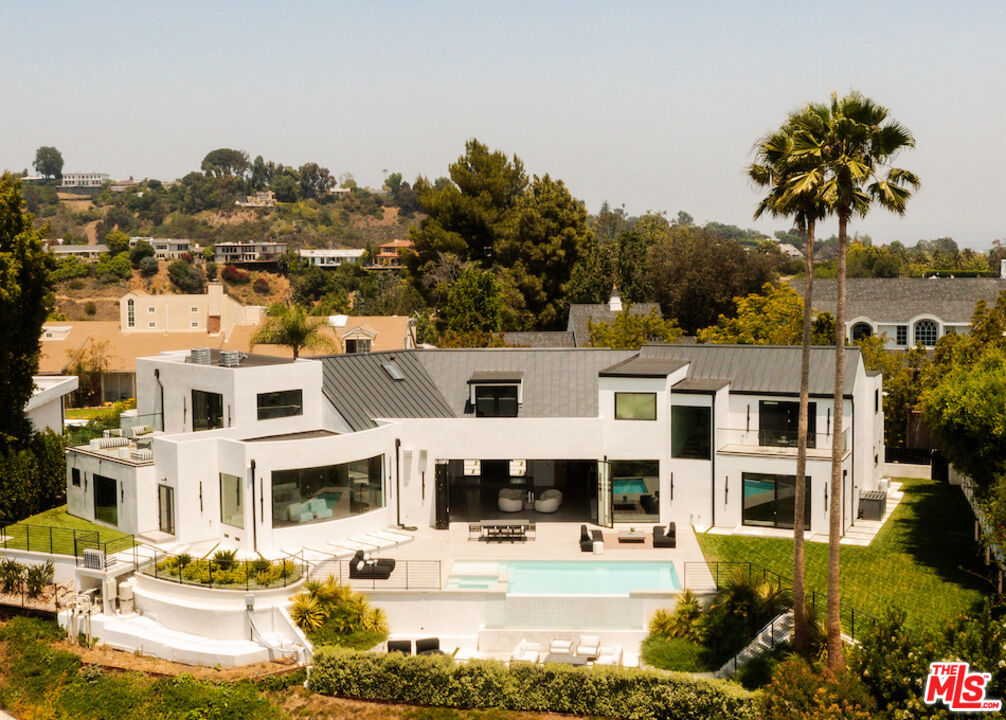 A nearly 8,000 square foot Architectural, set on over half an acre with commanding views of the Getty, Moraga Vineyards, and the Pacific Ocean. Double height walls of glass open up to resort-like grounds with an infinity pool, multiple terraces, and an expansive lawn.